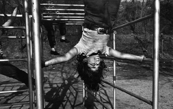 W. Eugene Smith: Juanita on Jungle Gym, 1944/c. 1950s, silver print, Photograph by W. Eugene Smith stamp on print verso, 8.5"x13.625".