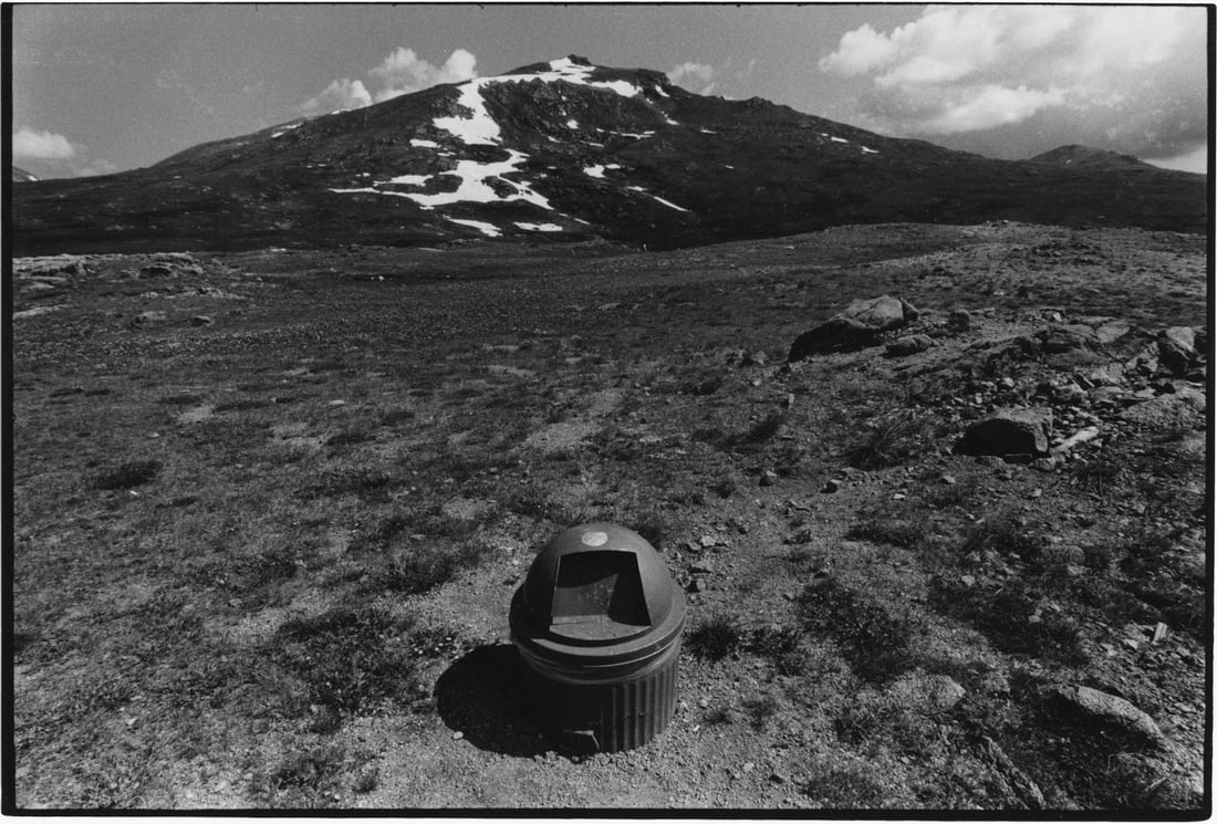 Nathan Lyons: Untitled (trash can and mountain) from the series Notations in Passing: Nathan Lyons: Untitled (trash can and mountain) from the series Notations in Passing, c. 1971, vintage gelatin silver print, signed on mount, Image size: 4.5" x 6.5"; Sheet Size: 4.5" x 6.75".