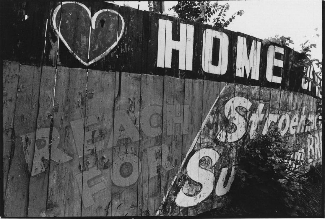 Nathan Lyons: Untitled (painted fence) from the series Notations in Passing: Nathan Lyons: Untitled (painted fence) from the series Notations in Passing, c. 1971, vintage gelatin silver print, signed on mount, Image size: 4.5" x 6.5"; Sheet Size: 4.25" x 6.375".