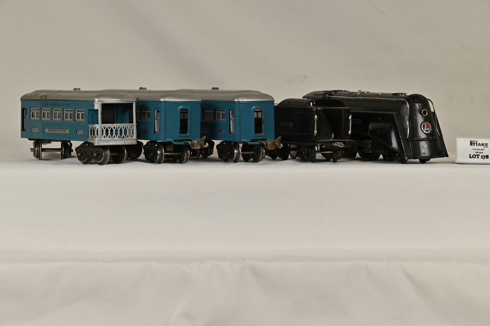 Lionel Prewar Black 264E & Tender w/ Blue/Silver 609, 609 & 611 Passenger Cars: Lionel Prewar Black 264E & Tender w/ Blue/Silver 609, 609 & 611 Passenger Cars. Loco and Tender are C7- but look very nice. The Loco is All Original and it Very Tough to Find an Original Cab without D