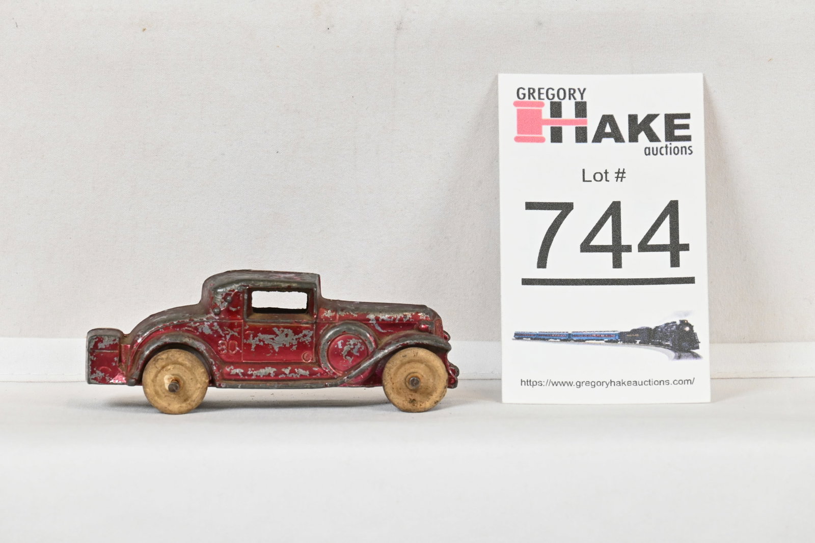 Vintage Red Kansas toys slush model of 1930s Coupe: Vintage Red Kansas toys slush model of 1930s Coupe, C6. About 3.5" long. Missing a partial wheel.