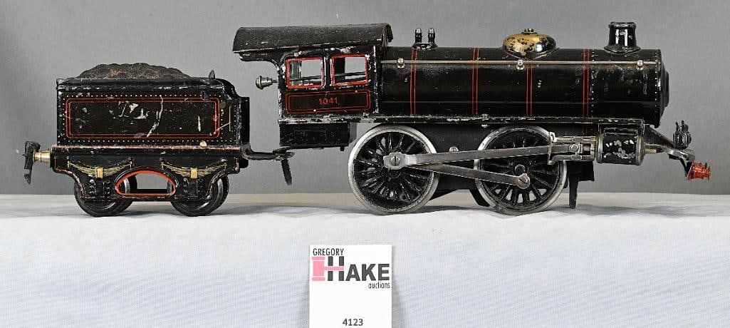 European Marklin or Bing 0-4-0 Clockwork Steam Locomotive and Tender Gauge 1: European Marklin or Bing 0-4-0 Clockwork Steam Locomotive and Tender Gauge 1, C7. One screw is missing that holds the side rod to the driver.