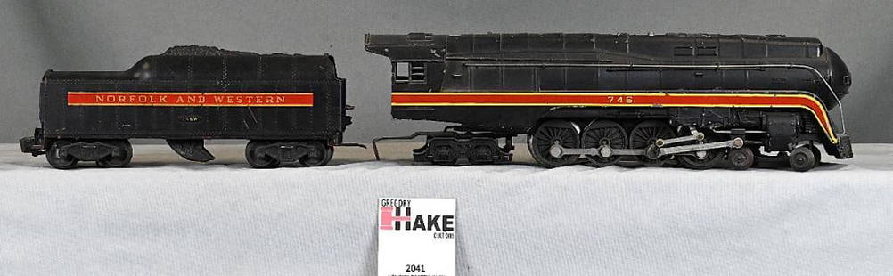 Lionel Postwar 746 N&W J Steam Locomotive w/ Short Stripe Tender: Lionel Postwar 746 N&W J Steam Locomotive w/ Short Stripe Tender, C6. Loco is missing front headlight lense. Tender has a small chip out the front right coal bunker. Size 12x5x4