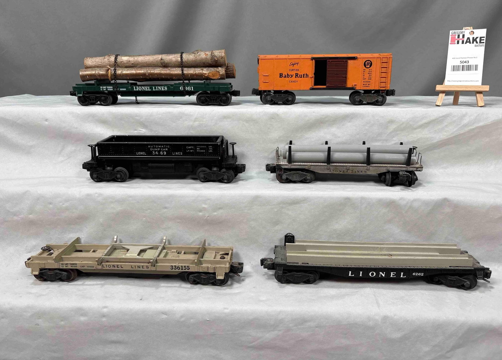 6 Lionel Postwar Freight Cars: 6 Lionel Postwar Freight Cars include 3469, 6411, 3361, 6262, 2454 and 6361. Cars are C7 and need to be cleaned and sold AS IS photographed. Size 17x12x4