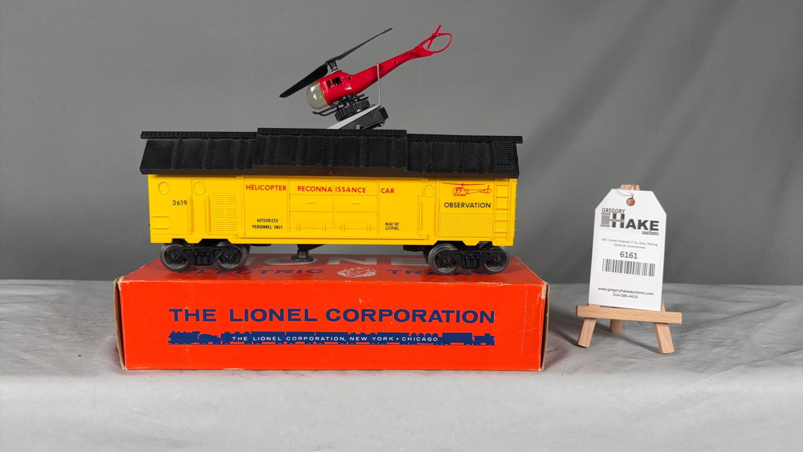 Lionel Postwar 3619 Reconnaissance Car w/Helicopter & OB: Lionel Postwar 3619 Reconnaissance Car w/Helicopter & OB. Car and helicopter are C8, box is a brick with great colors and graphics. Box has clear tape on one end.
