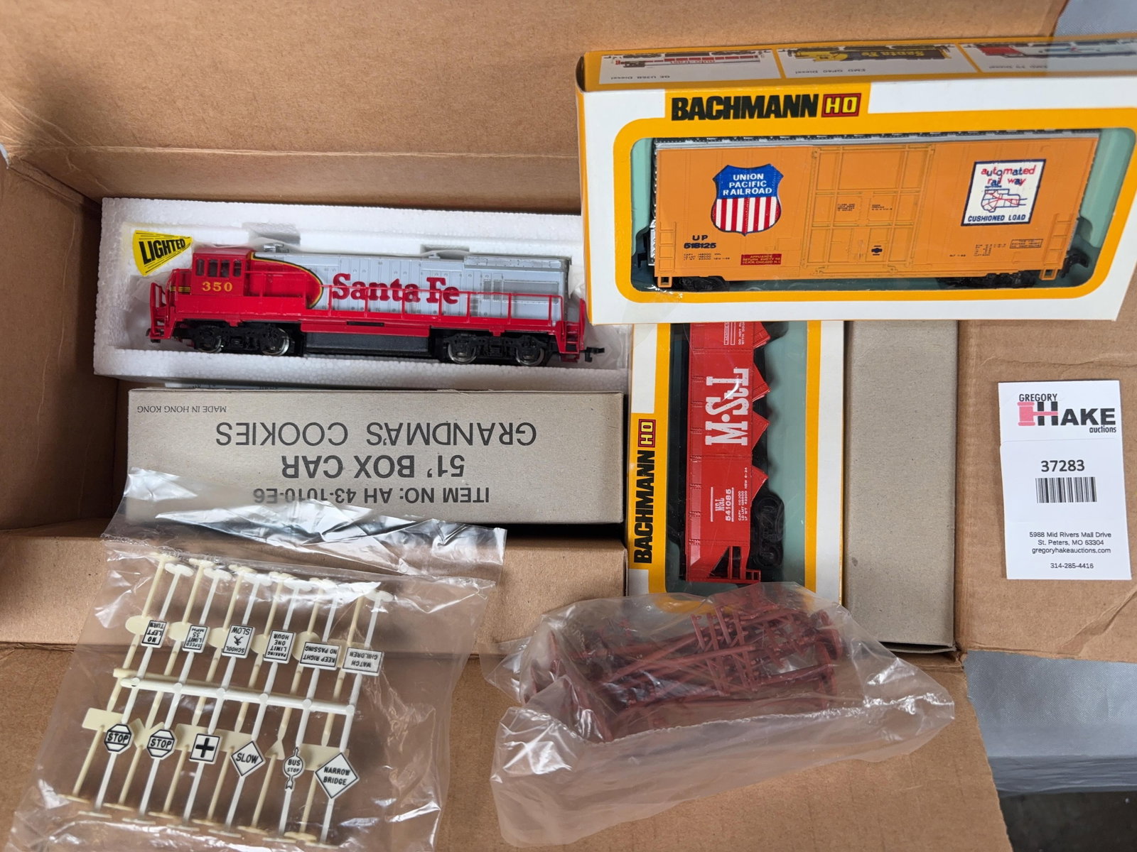 2 Boxes of Bachmann Trains and Accessories w/OB: 2 Boxes of Bachmann Trains and Accessories w/OB. Santa Fe Locomotive, UP, Grandma's Cookies Boxcar, Caboose, GATX Tank Car, railroad tracks, signage�+ more! Please see photos for details. ʏ