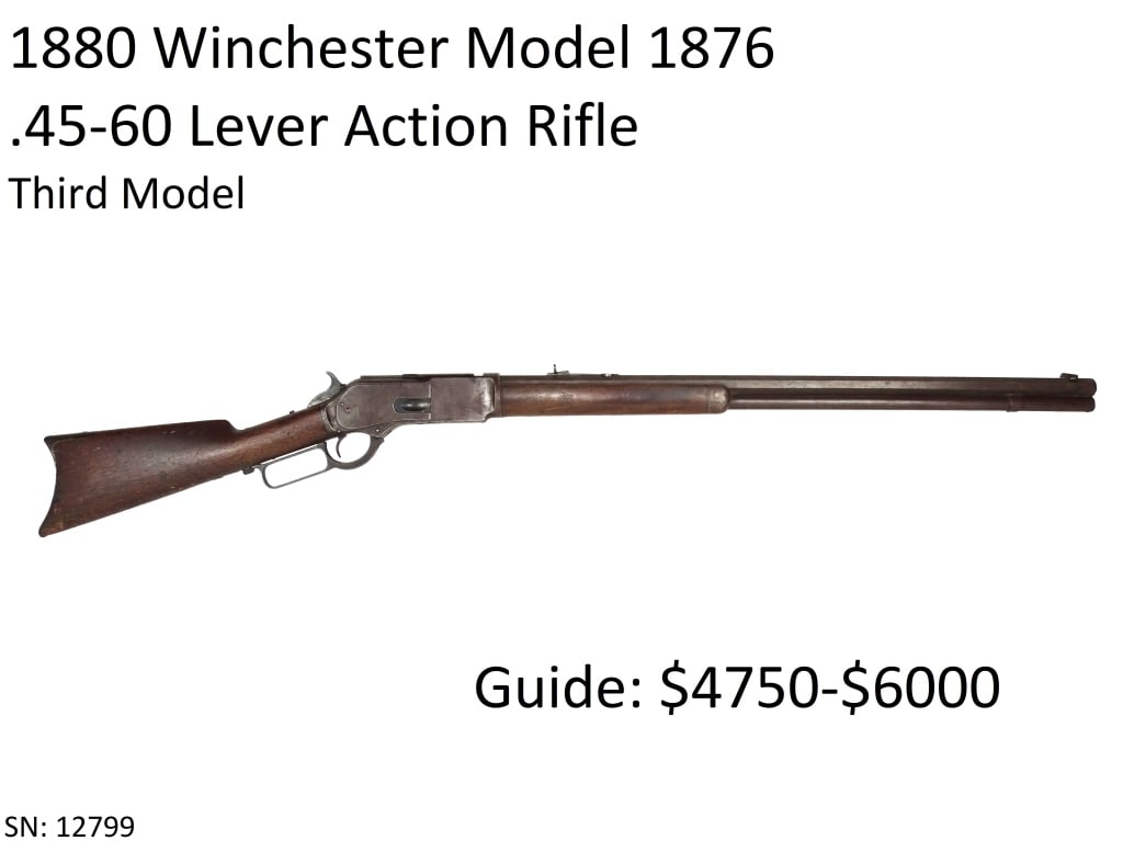 1880 Winchester Model 1876 .45-60 Rifle: Manufactured in 1886. This rifle has the Third Model receiver with integral dust cover rail and dust cover with serrated edges. Dovetail blade front sight and "1876" marked folding ladder rear sight o