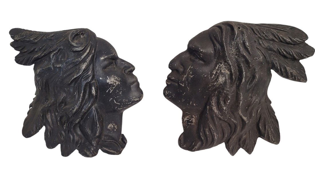 Cast Iron Pair of Native American Profiles: Pair of cast iron Native American profiles painted black. Dimensions: 10 inches tall by 11 inches & 9.5 inches tall x 9 inches wide. Condition: Good -paint scuffs. Please feel free to ask for a condi