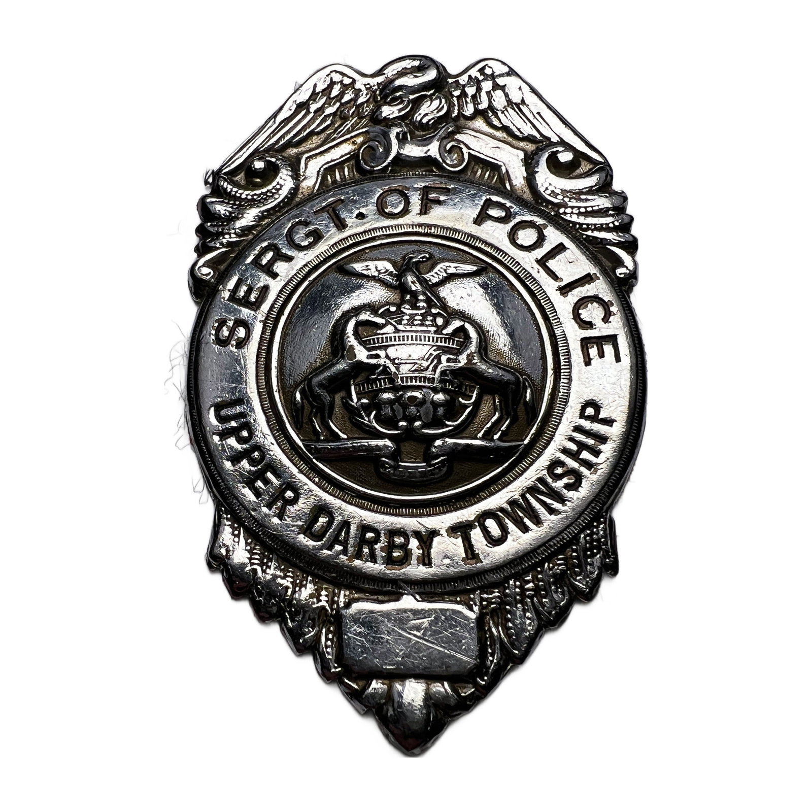 Obsolete Mid-Century Upper Darby Township PA Sergeant of Police Badge: Obsolete Mid-Century Upper Darby Township PA Sergeant of Police Badge. Measures approximately 2.75"H x 1.75"W. Missing pinThe estate had them all glued to a velvet board that is why the pins are missi