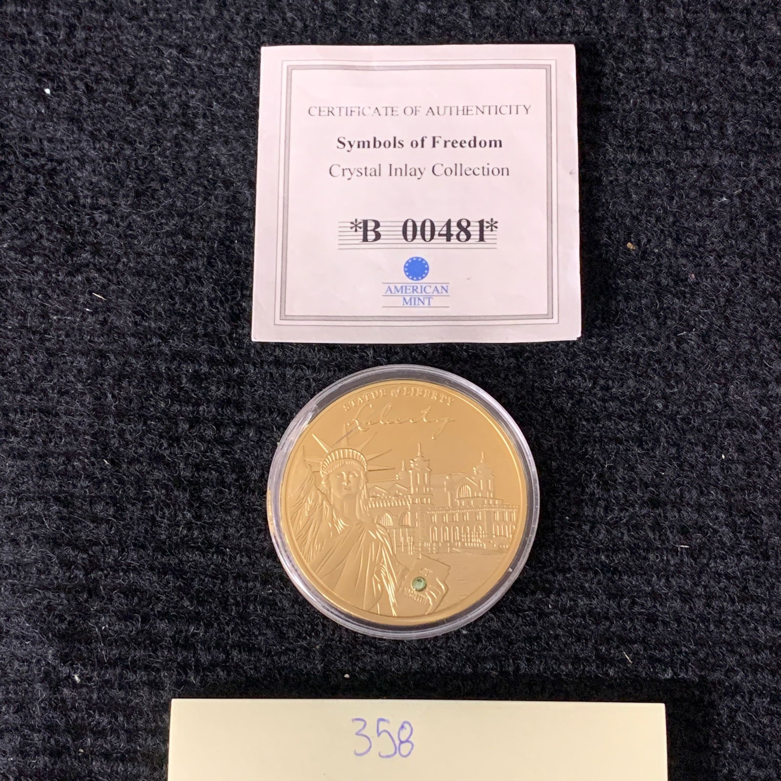 Gold Statue of Liberty Chrystal inlay Coin: Symbols of Freedom Crystal Inlay Collection. Statue of Liberty Proof. Layered in 24k Gold with Swarovski Cystal. Includes CoA. We are a veteran owned company. Please look at the pictures carefully to