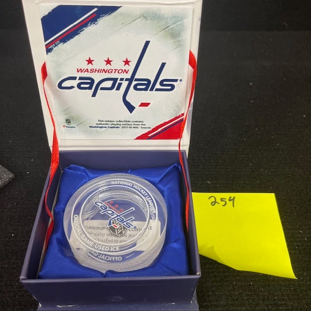 Capitals Game Used Ice Puck w/ Display: Beautiful display case with a see through puck of game used ice. This was given as a gift to Season Ticket Holders.We are a veteran owned company. Please look at the pictures carefully to determine wh