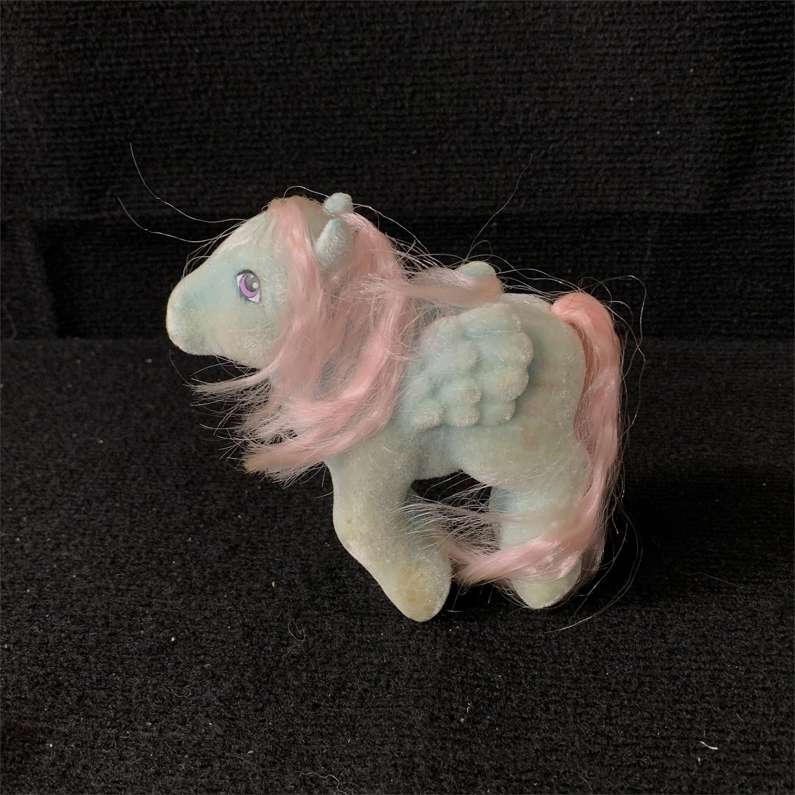 My Little Pony G1 Year 4 MLP Wind Whistler: G1 MLP Year 4 (85-86) So Soft Pony Wind Whistler. The pink color in her tail and mane is nice and bright with no apparent hair cuts. She is missing a slight amount of flocking on the tip on one ear bu