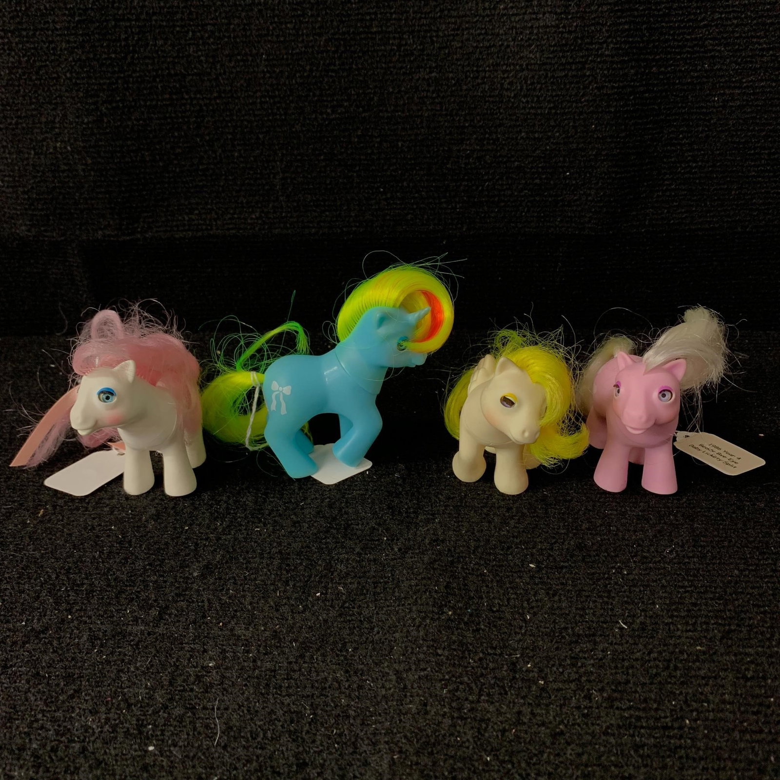 Lot of 4 Baby Ponies with Beddy Bye Eyes: G1 MLP Year 4 (85-86) Baby Ponies with Beddy Bye Eyes including Baby Lickety-Split, Baby Lofty, Baby Ribbon and Baby Sundance. All are in excellent played with condition except for Baby Ribbon which h