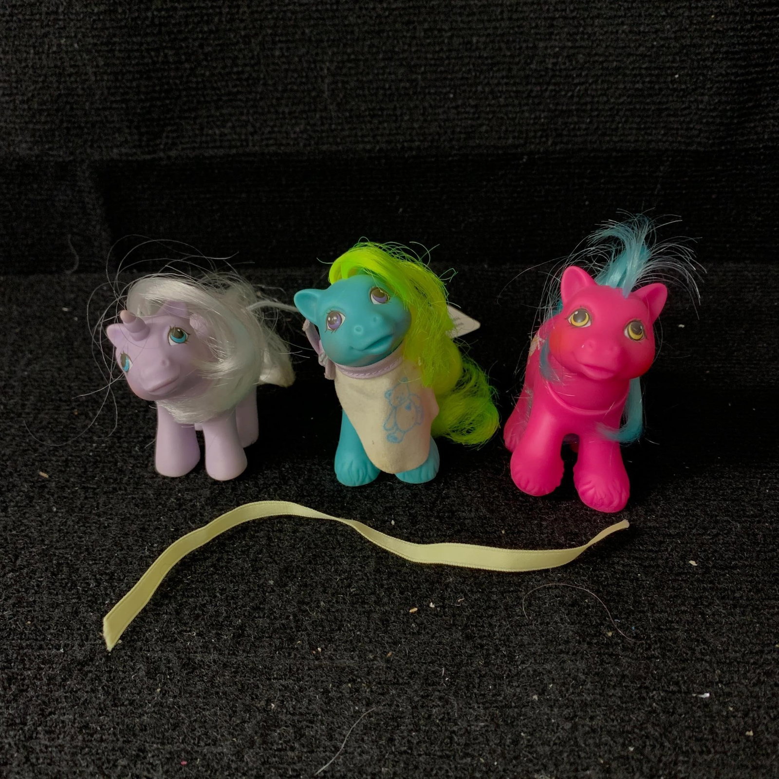 Baby Noddins, Baby Ribbs & Baby Whirly-Twirl: G1 MLP Year 6 (87-88) Peek-a-Boo Baby Ponies including Baby Noddins, Baby Ribbs (with original bib) and Baby Whirly-Twirl. All of these baby ponies have heads that can turn. Baby Ribbs and Baby Whirly