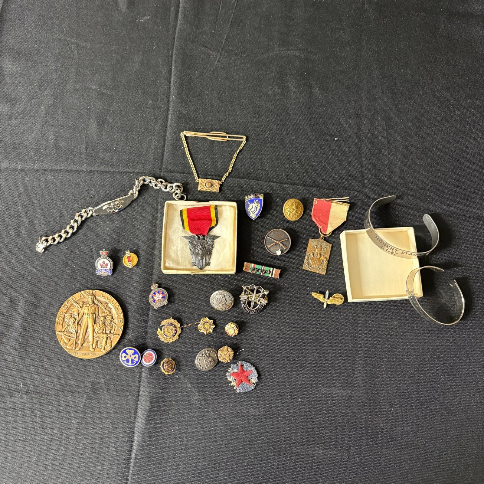 Group of Medals, Pins, & Bracelets: Please look at photos carefully. All sales are final. Items sold as is. We offer virtual and in person previews of any lots up until auction day. By placing a bid you agree to allow us to charge the c