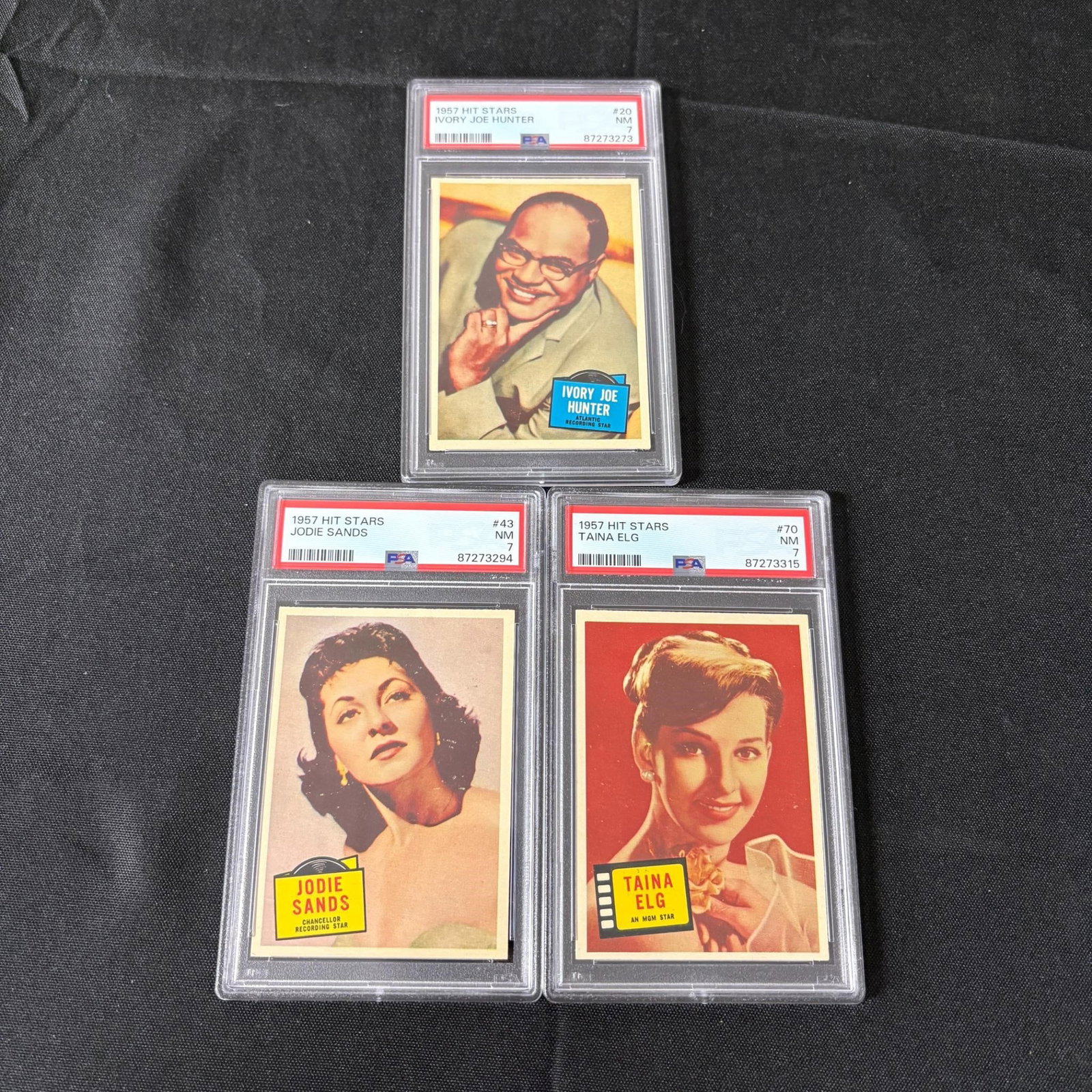PSA 7 Graded Hit Stars Trading Cards: 1957 Topps Hit Stars Trading Cards. Ivory Joe Hunter, Jodie Sands, Taina Elg. Please look at photos carefully. All sales are final. Items sold as is. We offer virtual and in person previews of any lot