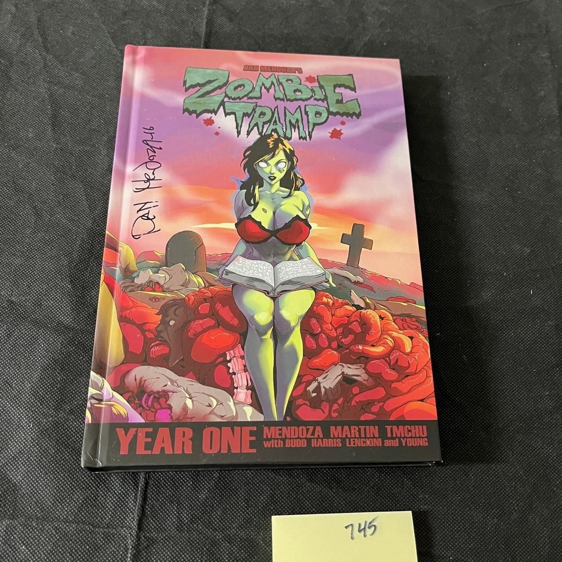 Zombie Tramp Year One HC Signed by Dan Mendoza: We are a veteran owned company. Please look at the Photos Carefully to determine condition of lot. All lots sold as is. Please message if you have any questions. By placing a bid, you agree to the ter
