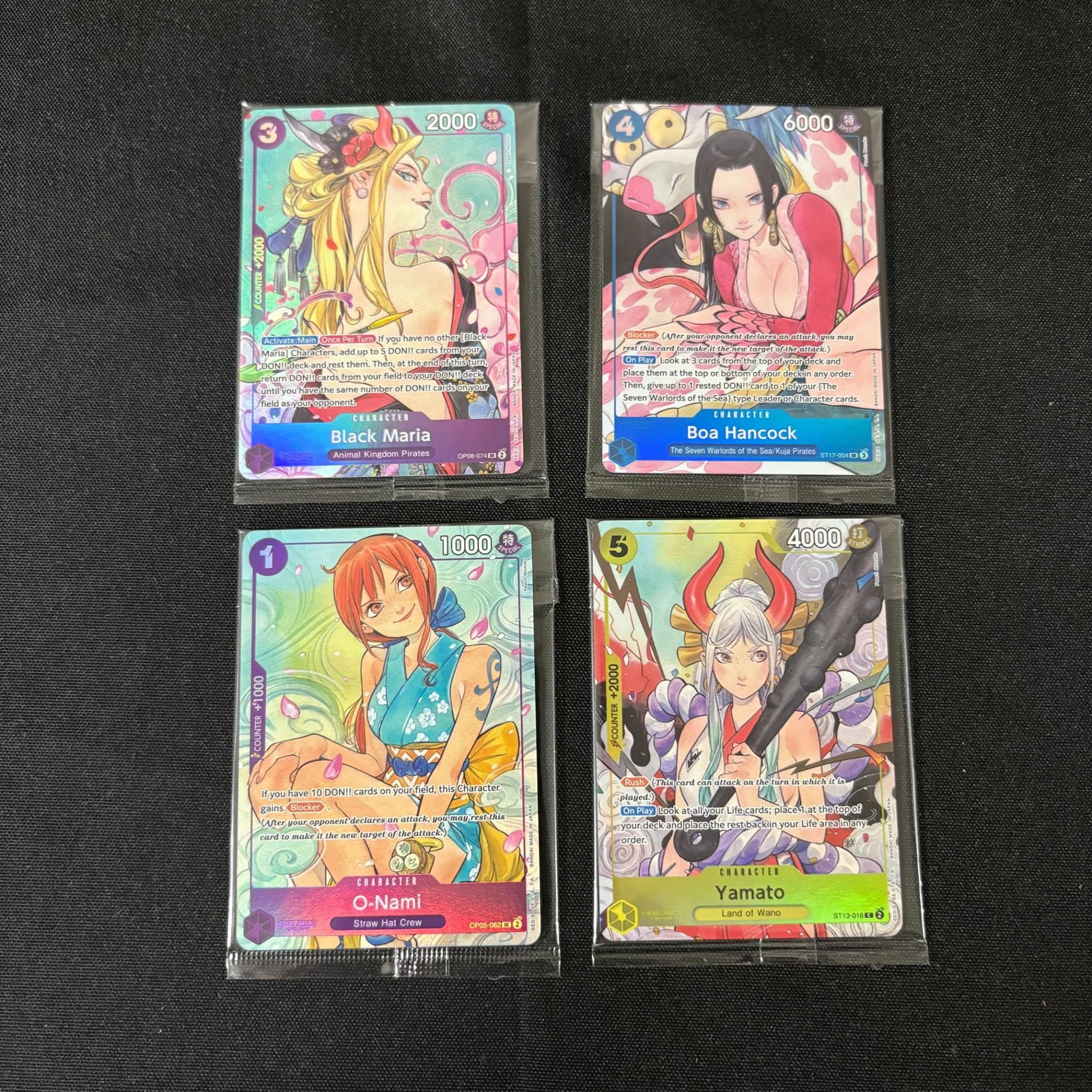 Sealed One Piece Promo Cards: Black Maria, O-Nami, Boa Hancock, Yamato Sealed One Piece Promo Cards. All items are sold as is. Please look at pictures carefully to determine what you believe are the condition of each lot. By choos