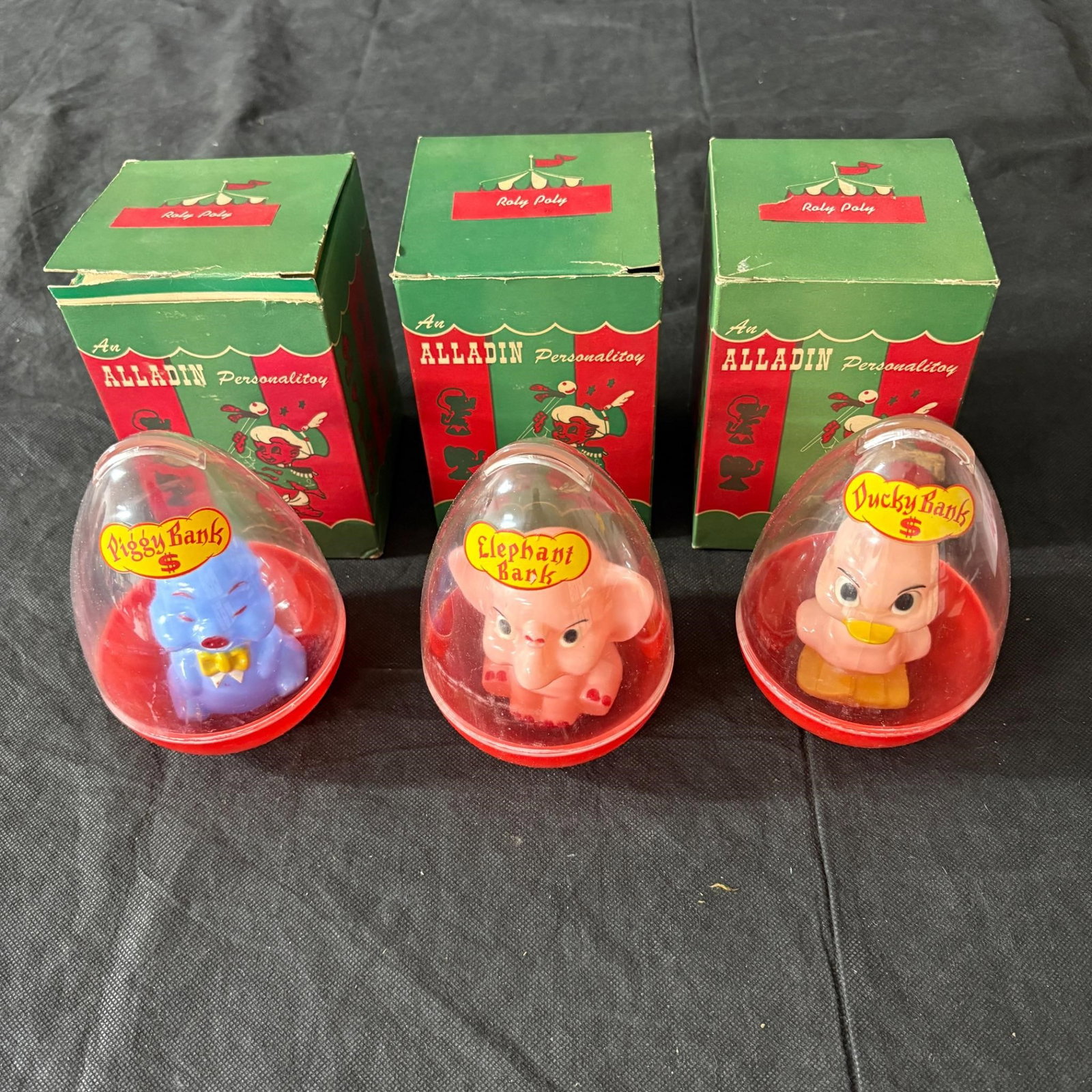 Antique Alladin Roly Poly Coin Banks: Original Boxes, Antique AlladinPersonalitoy Roly Poly Coin Banks Includes Piggy Bank, Elephant Bank, and Ducky Bank. All items are sold as is. Please look at pictures carefully to determine what you b
