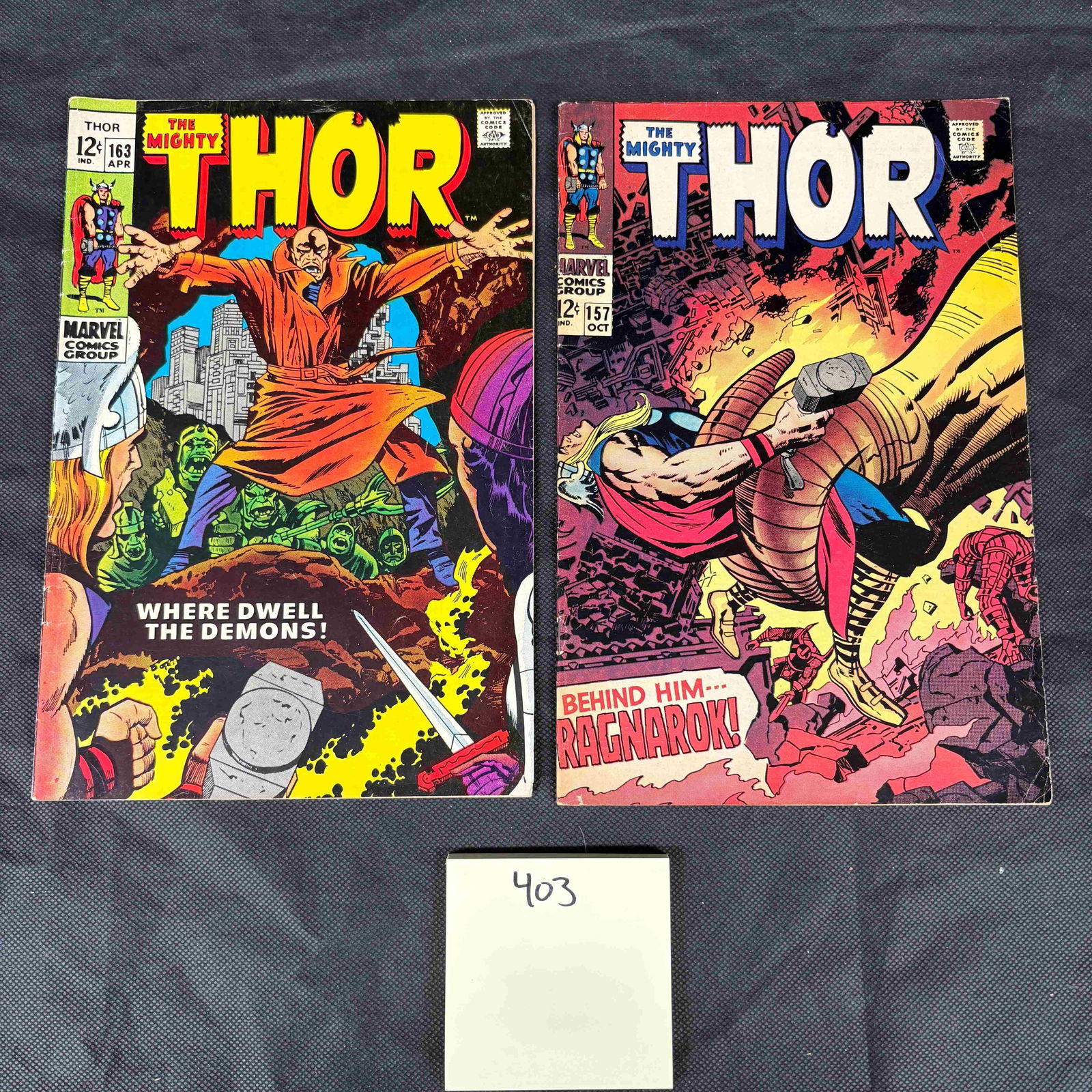 A Pair of The Mighty Thor Marvel Comics, Issues #157 and #163: A pair of vintage American comic books, titled 'The Mighty Thor' from the Marvel Comics Group. Issue #157, dated OCT, features Thor battling a giant hand amidst fire on the cover, with the text 'BEHIN