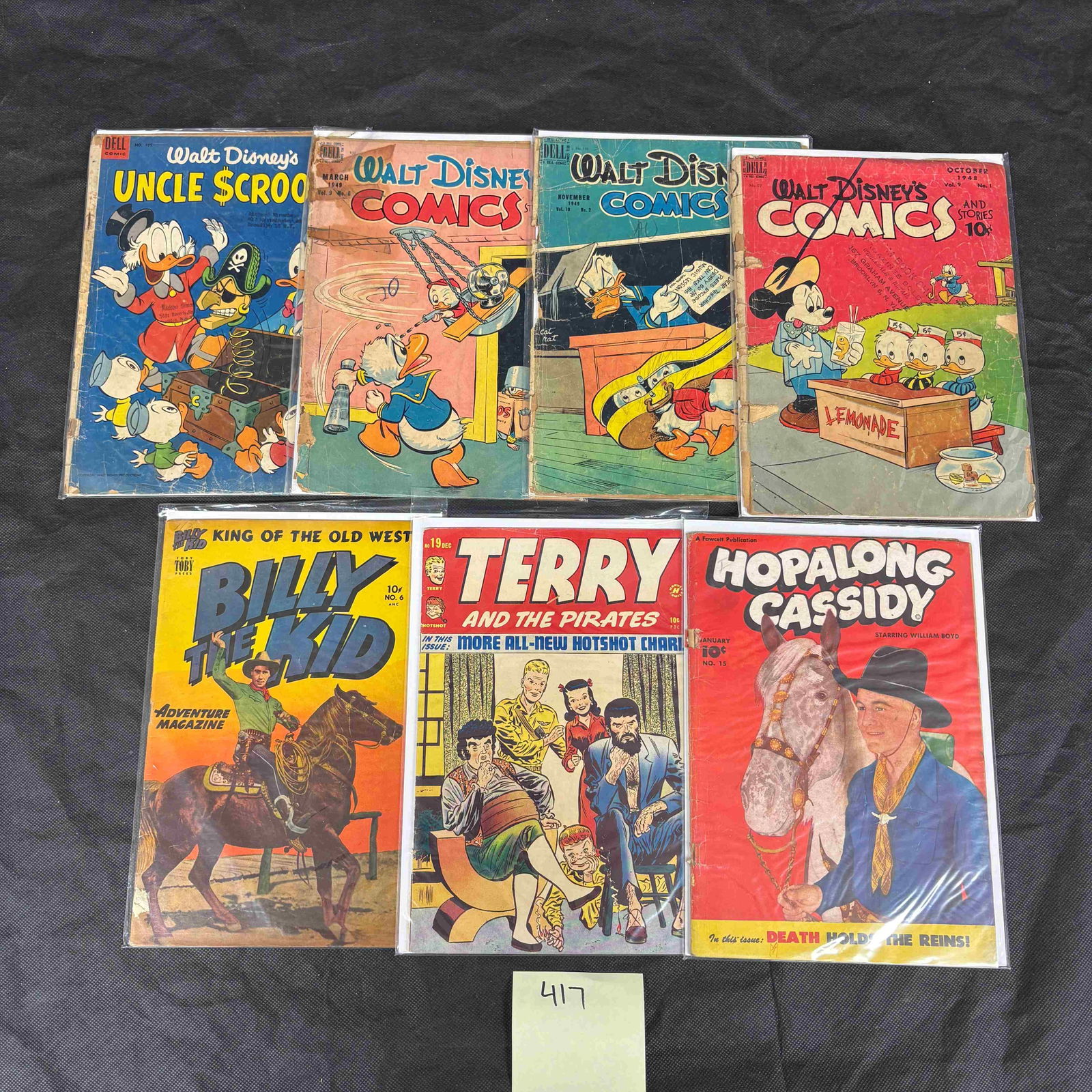 A Group of Vintage American Comic Books, including Terry and the Pirates, Walt Disney, Billy The: A group of seven vintage American comic books, primarily from the late 1940s to early 1950s. The lot includes: 'Terry and the Pirates' (10Â? PDC), published by Harvey Comics; 'Walt Disney's Uncle Scr