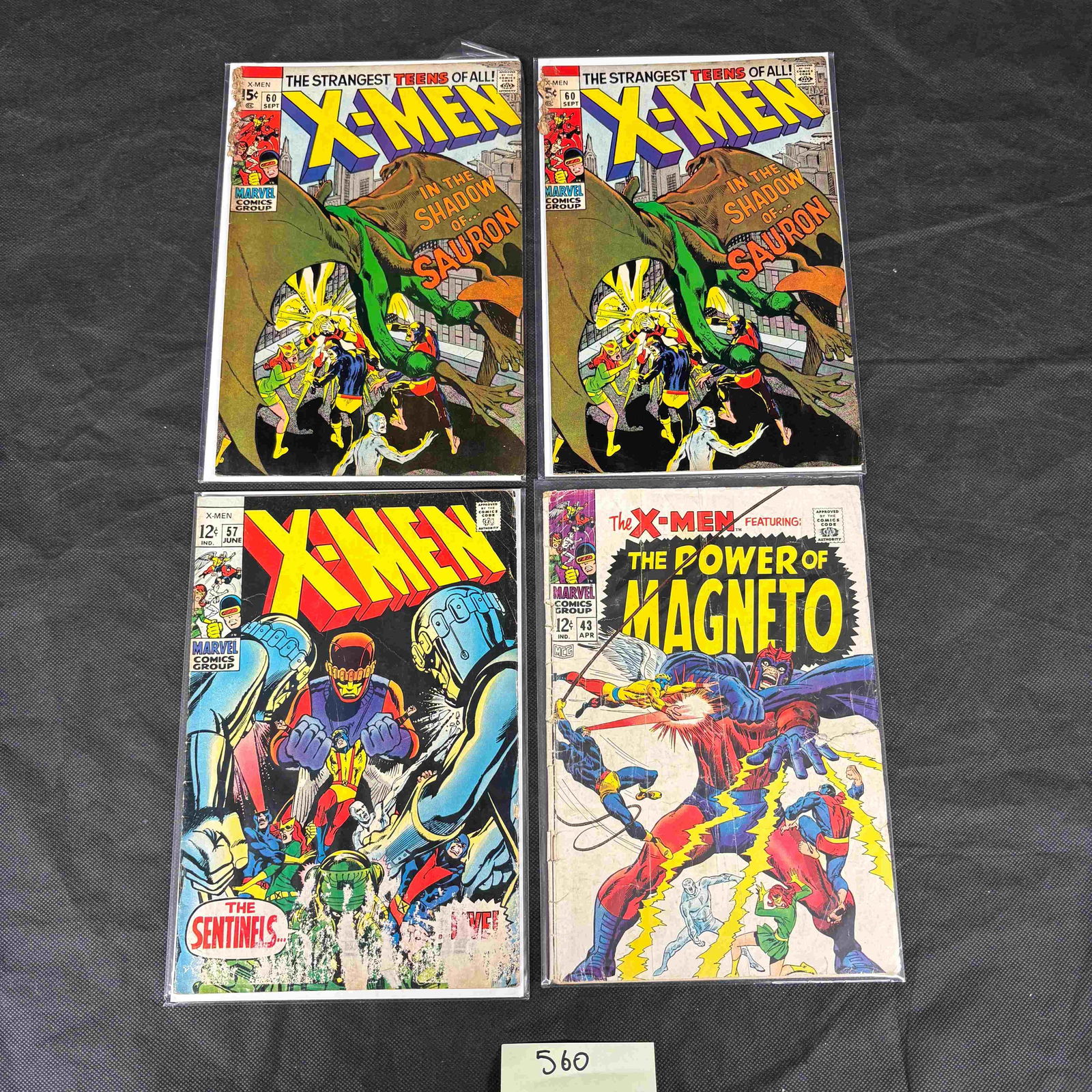 Four Marvel Comics Group X-Men Comic Books, comprising issues #43, #57, and two copies of #60: A group of four vintage Marvel Comics Group X-Men comic books, individually protected in clear plastic sleeves. The lot includes two copies of issue #60 (August, 15Â?) titled "THE STRANGEST TEENS OF