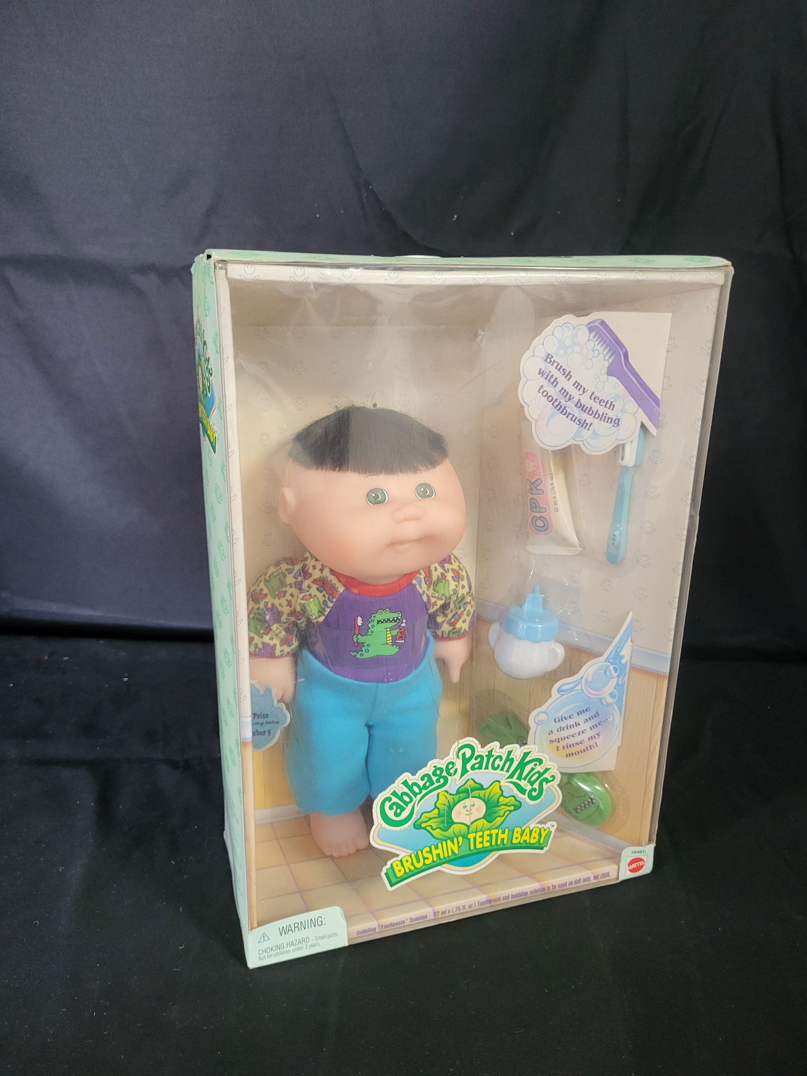I00531 Mattel Cabbage Patch Kids Brushin' Teeth Baby Doll: BID PER WHAT YOU SEE IN THE PHOTO, NOT THE AI GENERATED TITLES AND DESCRIPTIONS! This 1997 Mattel Cabbage Patch Kids Brushin' Teeth Baby doll is presented in its original factory packaging. The 12-inc