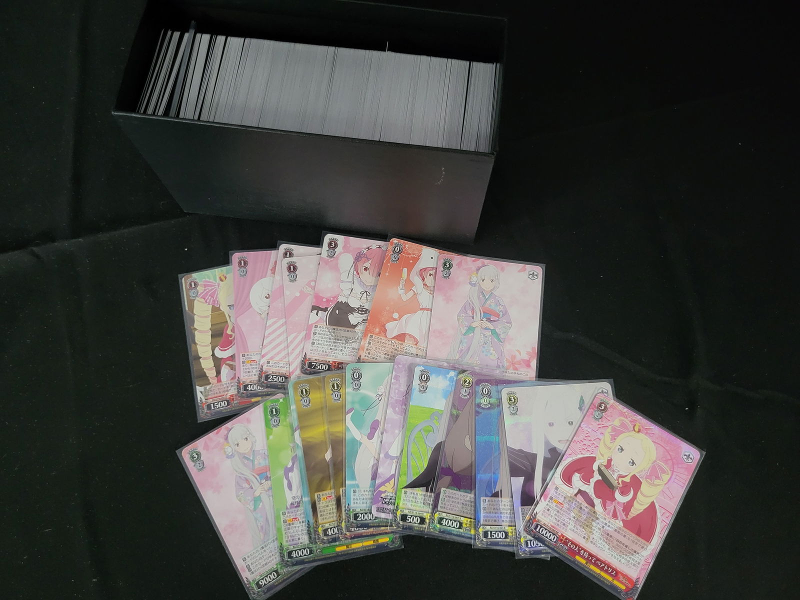 I00227 A Collection of Weiss Schwarz Re:Zero Starting Life in Another World Trading Cards including: BID PER WHAT YOU SEE IN THE PHOTO, NOT THE AI GENERATED TITLES AND DESCRIPTIONS! A collection of Weiss Schwarz trading cards featuring characters from the Re:Zero - Starting Life in Another World seri