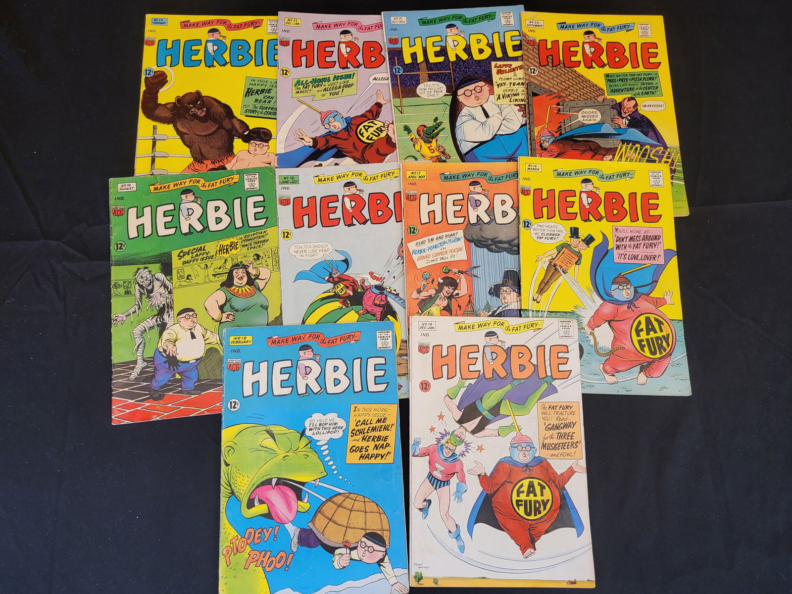 A Collection of Herbie Comic Books, American Comics Group (ACG), Issues 14-23: BID PER WHAT YOU SEE IN THE PHOTO, NOT THE AI GENERATED TITLES AND DESCRIPTIONS! A collection of vintage Herbie comic books published by the American Comics Group (ACG) during the mid-1960s. This grou