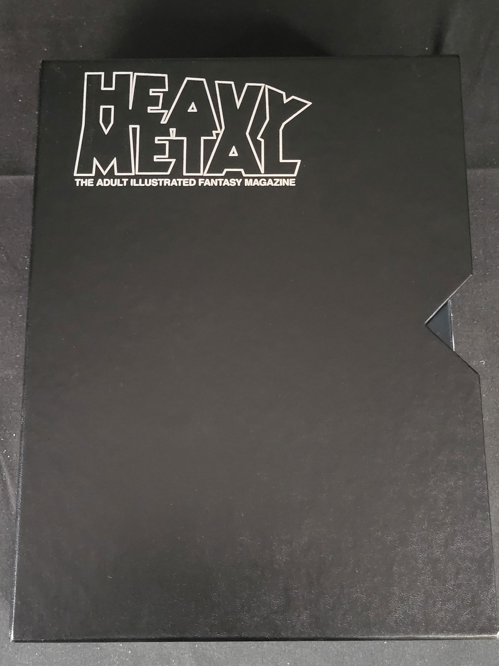 A Collection of Heavy Metal Magazines in Slipcase and Vintage DC Comic Books: BID PER WHAT YOU SEE IN THE PHOTO, NOT THE AI GENERATED TITLES AND DESCRIPTIONS! This collection features several issues of Heavy Metal: The Adult Illustrated Fantasy Magazine alongside an assortment