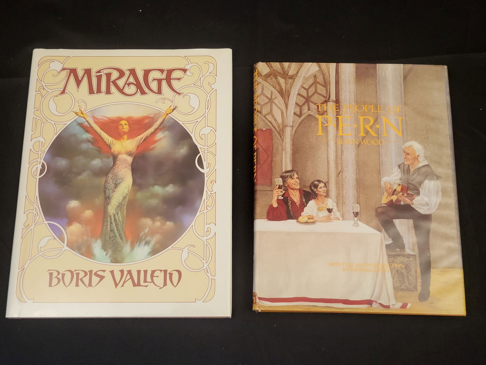 A Pair of Fantasy Art Books Including Mirage by Boris Vallejo and The People of Pern by Robin Wood: BID PER WHAT YOU SEE IN THE PHOTO, NOT THE AI GENERATED TITLES AND DESCRIPTIONS! A pair of hardbound fantasy art books with original dust jackets. The first volume is Mirage by Boris Vallejo, publishe