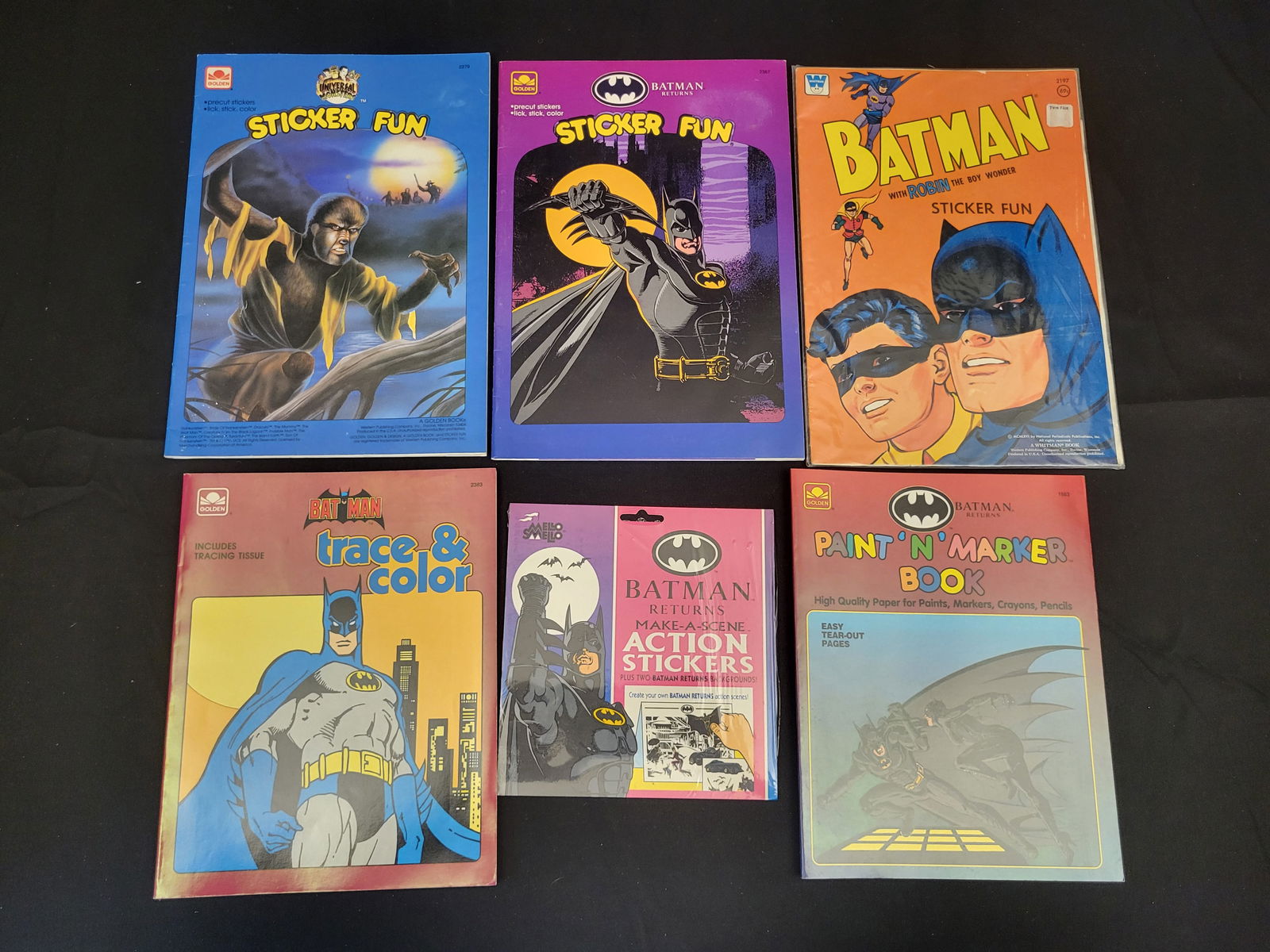 A Collection of Vintage Batman and Universal Monsters Sticker and Activity Books: BID PER WHAT YOU SEE IN THE PHOTO, NOT THE AI GENERATED TITLES AND DESCRIPTIONS! A collection of vintage activity and sticker books featuring DC Comics Batman and Universal Monsters characters. The gr