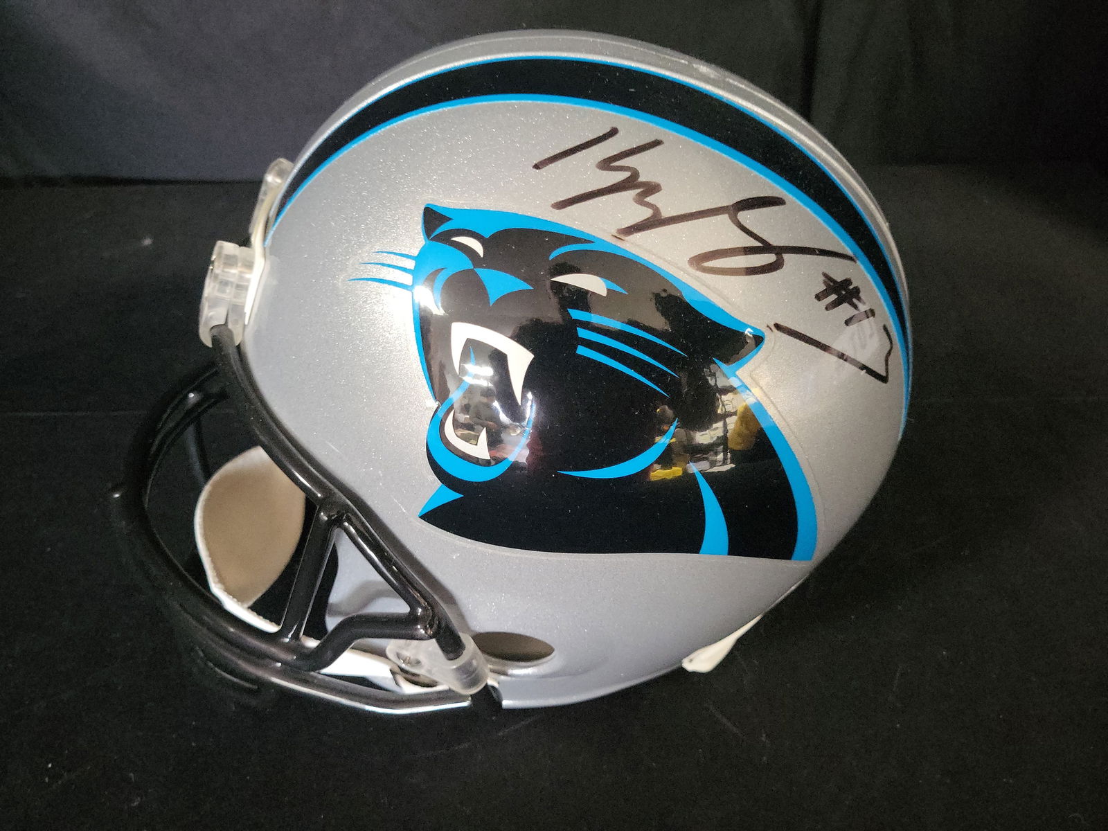 I01085 | Muggsy Bogues Signed Carolina Panthers Full-Size Replica Helmet, Witnessed Authentication: BID PER WHAT YOU SEE IN THE PHOTO, NOT THE AI GENERATED TITLES AND DESCRIPTIONS! Muggsy Bogues Signed Carolina Panthers Full-Size Replica Helmet, Witnessed AuthenticationThis unique sports crossover c