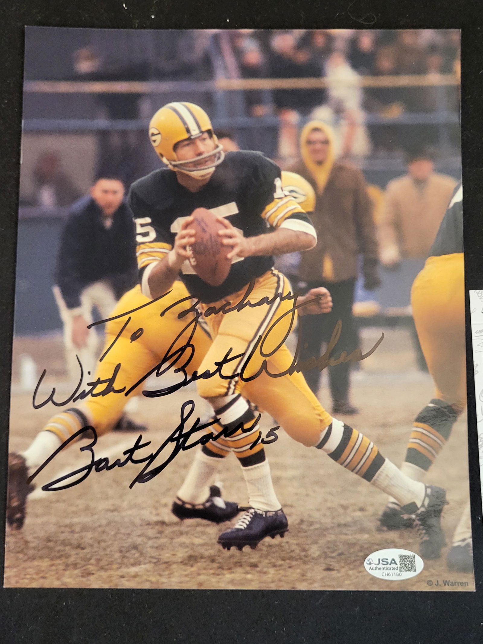 I00717 | Bart Starr Autographed Green Bay Packers Action Photograph: BID PER WHAT YOU SEE IN THE PHOTO, NOT THE AI GENERATED TITLES AND DESCRIPTIONS! Bart Starr Autographed Green Bay Packers Action Photograph This lot features a color glossy photograph hand-signed by G