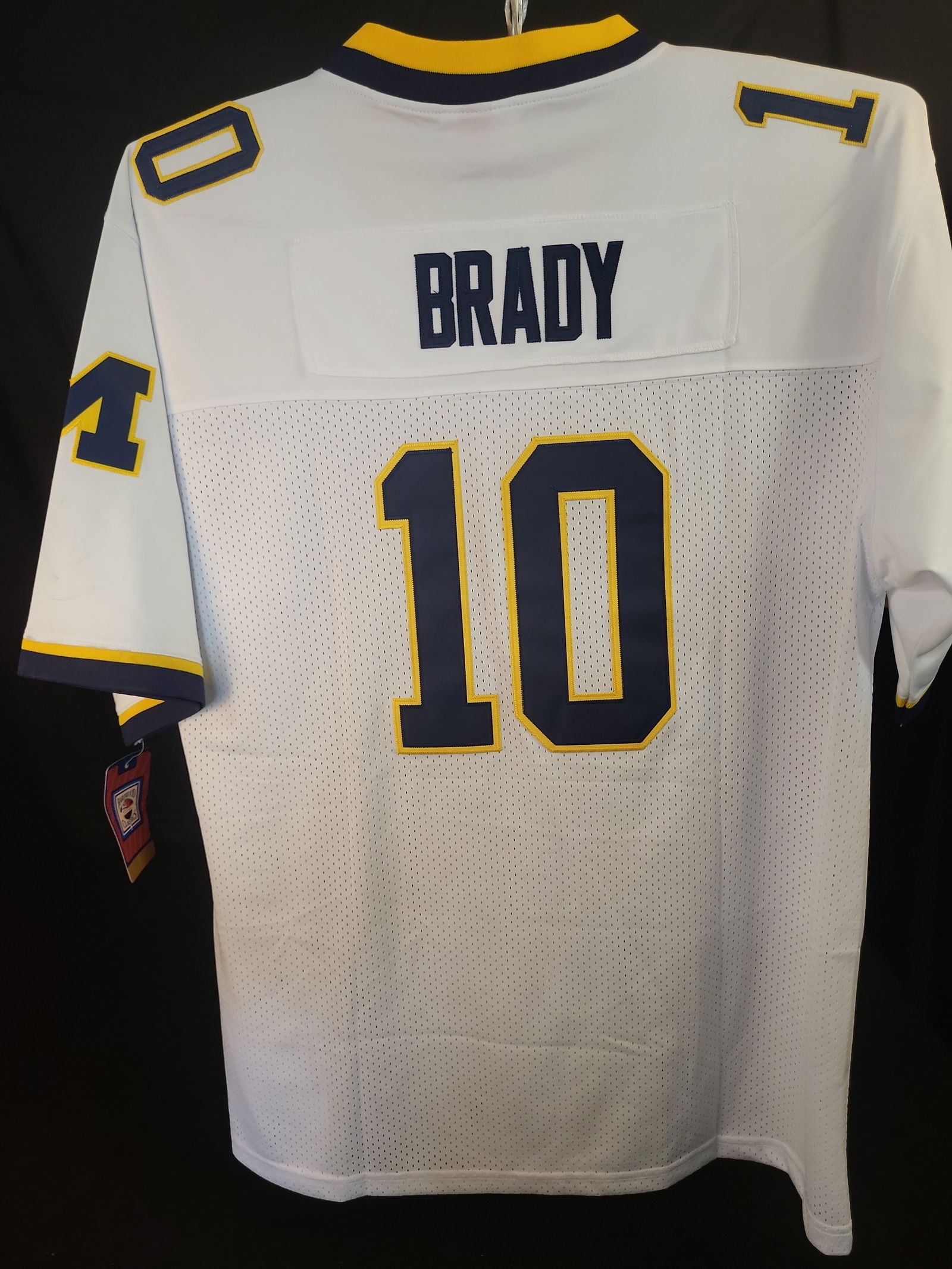 I01070 | Tom Brady Michigan Wolverines Mitchell & Ness 1999 College Vault Throwback Jersey: BID PER WHAT YOU SEE IN THE PHOTO, NOT THE AI GENERATED TITLES AND DESCRIPTIONS! Tom Brady Michigan Wolverines Mitchell & Ness 1999 College Vault Throwback Jersey This is a professionally manufactured