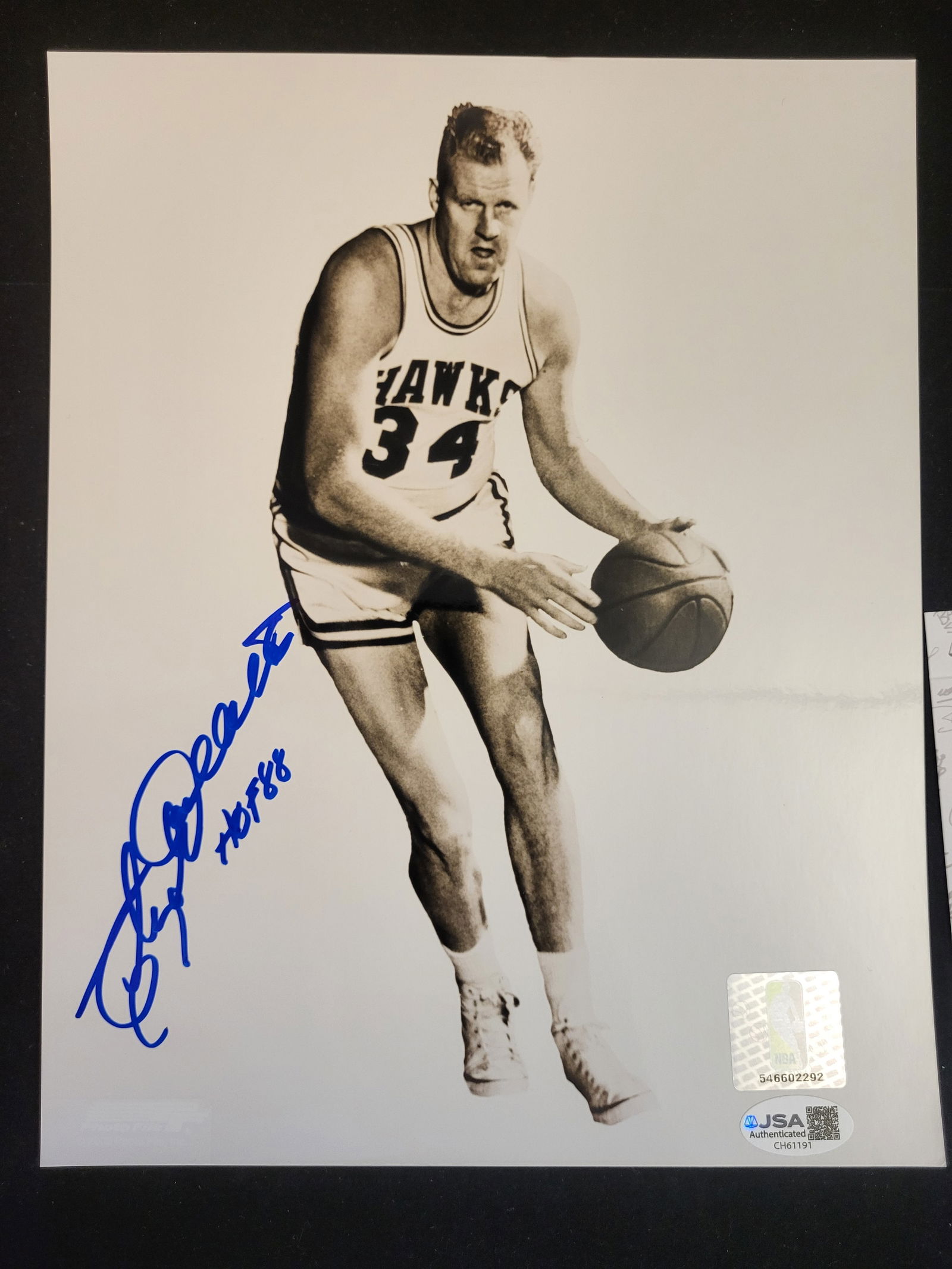 I00710 | Cliff Hagan Autographed St. Louis Hawks 8x10 Photograph: BID PER WHAT YOU SEE IN THE PHOTO, NOT THE AI GENERATED TITLES AND DESCRIPTIONS! Cliff Hagan Autographed St. Louis Hawks 8x10 PhotographAn autographed black and white action photograph of Basketball H