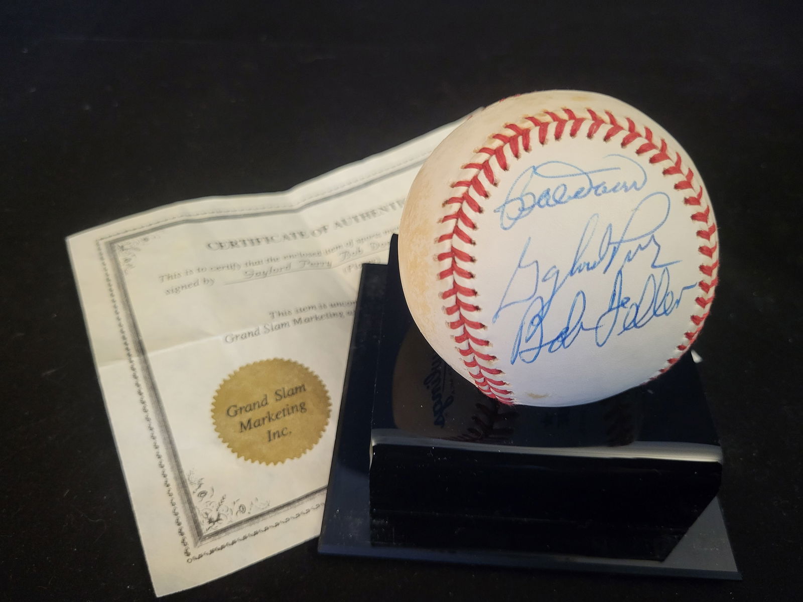 I00637 | Multi-Signed Baseball Featuring Gaylord Perry, Bob Doerr, and Bob Feller: BID PER WHAT YOU SEE IN THE PHOTO, NOT THE AI GENERATED TITLES AND DESCRIPTIONS! Multi-Signed Baseball Featuring Gaylord Perry, Bob Doerr, and Bob FellerThis baseball features the blue ink signatures