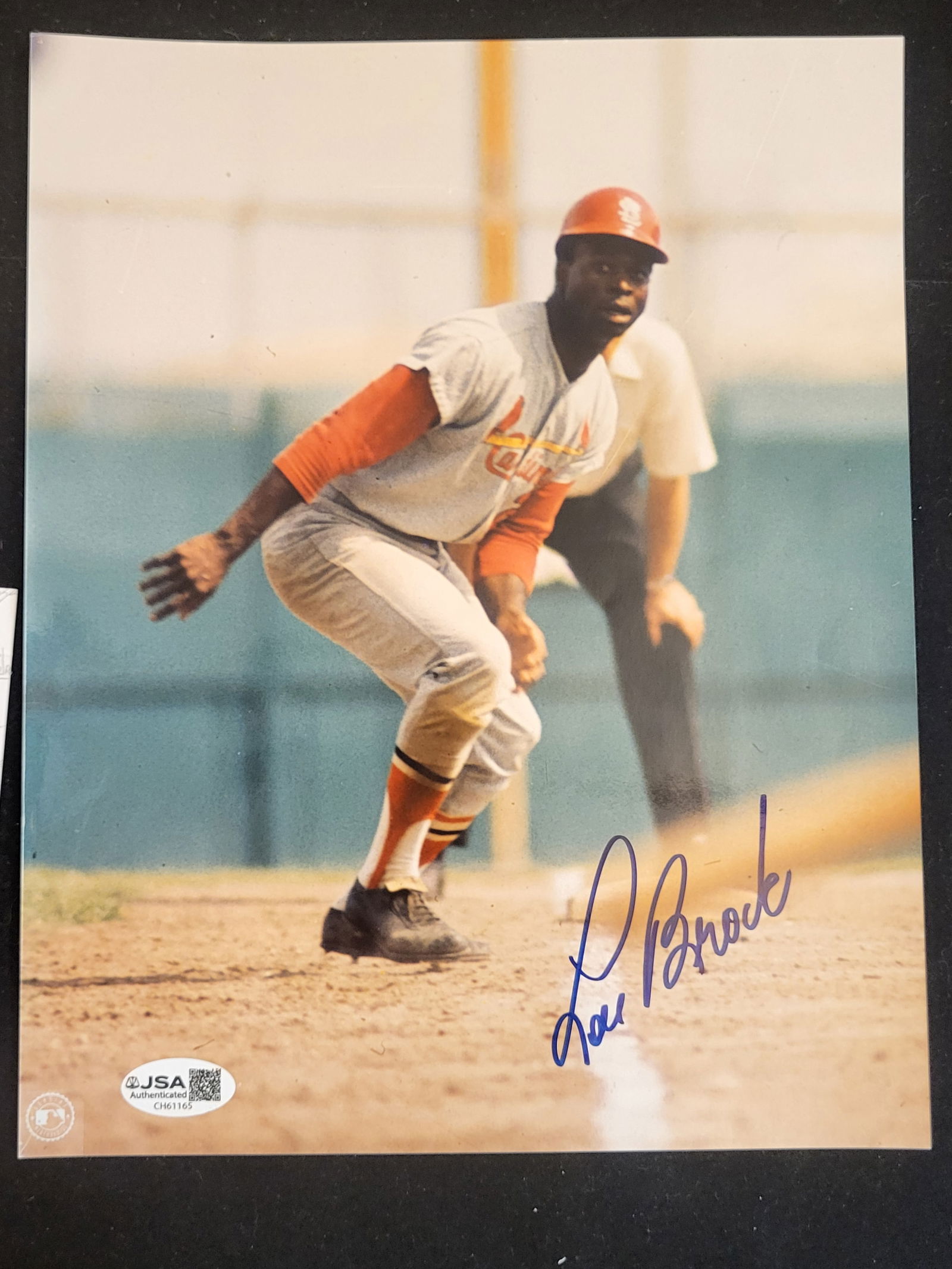 I00721 | Lou Brock Autographed St. Louis Cardinals Action Photograph with JSA Authentication: BID PER WHAT YOU SEE IN THE PHOTO, NOT THE AI GENERATED TITLES AND DESCRIPTIONS! Lou Brock Autographed St. Louis Cardinals Action Photograph with JSA Authentication This lot consists of a color action