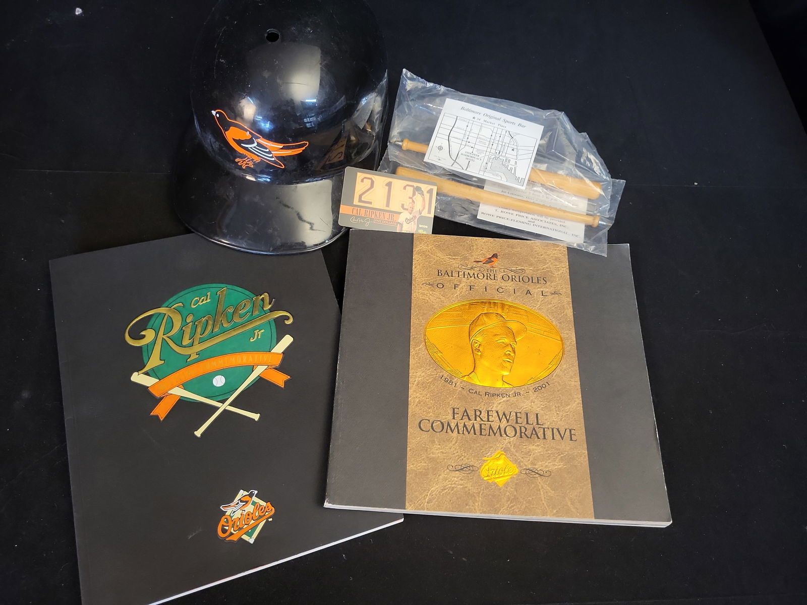 I01048 | Cal Ripken Jr., Baltimore Orioles Commemorative Memorabilia Lot, Unauthenticated: BID PER WHAT YOU SEE IN THE PHOTO, NOT THE AI GENERATED TITLES AND DESCRIPTIONS! Cal Ripken Jr., Baltimore Orioles Commemorative Memorabilia Lot, Unauthenticated This lot features a collection of Balt