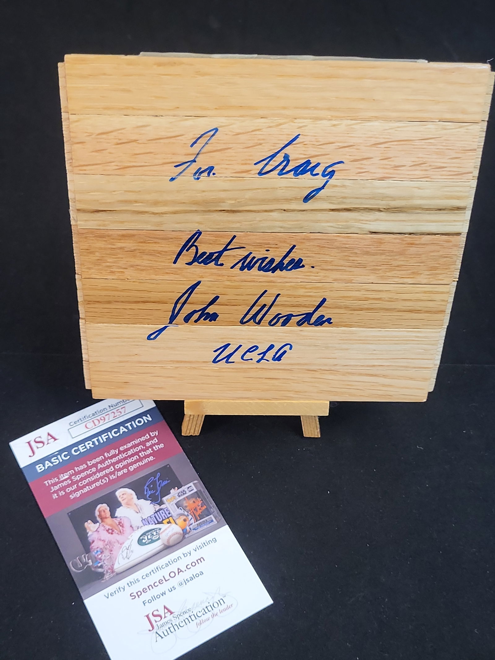 I00883 | John Wooden Signed UCLA Basketball Court Floorboard, JSA Authenticated: BID PER WHAT YOU SEE IN THE PHOTO, NOT THE AI GENERATED TITLES AND DESCRIPTIONS! John Wooden Signed UCLA Basketball Court Floorboard, JSA Authenticated This professionally authenticated collectible fe