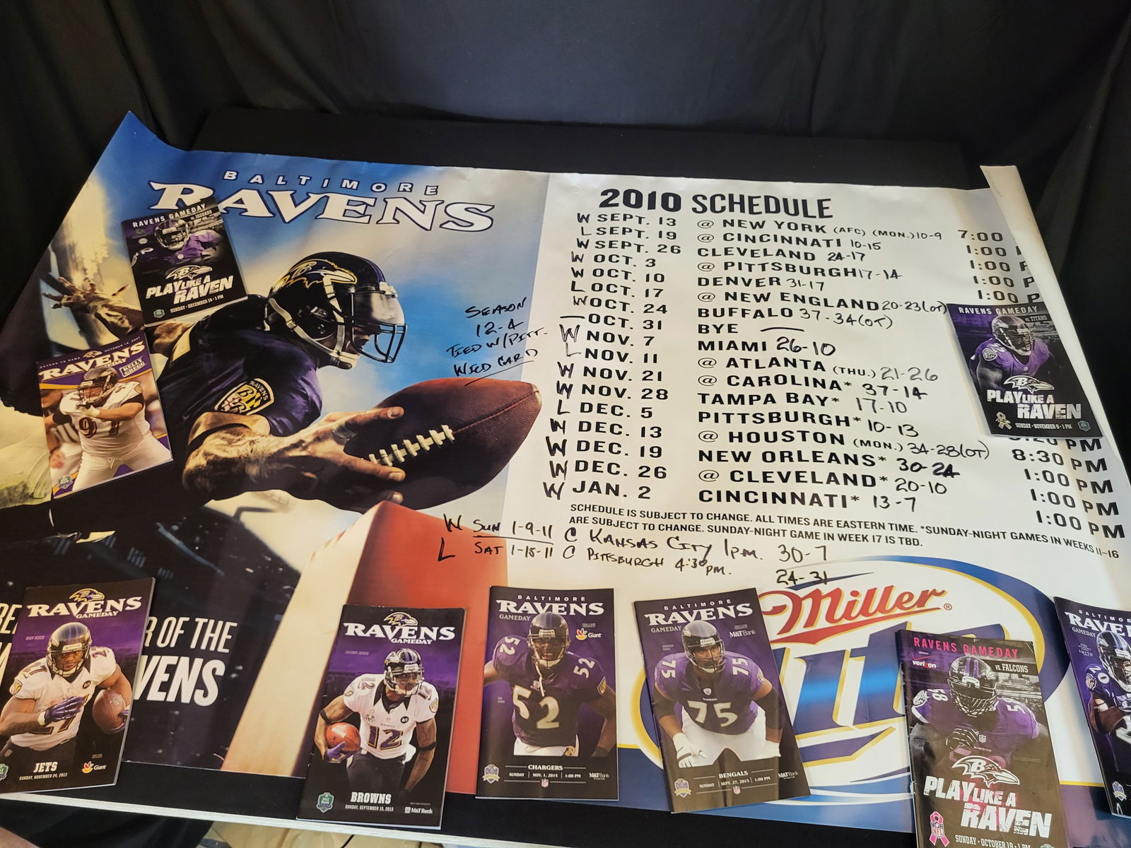 I00592 | A Collection of Baltimore Ravens Gameday Programs and 2010 Season Schedule Poster: BID PER WHAT YOU SEE IN THE PHOTO, NOT THE AI GENERATED TITLES AND DESCRIPTIONS! A Collection of Baltimore Ravens Gameday Programs and 2010 Season Schedule Poster A collection of Baltimore Ravens prof