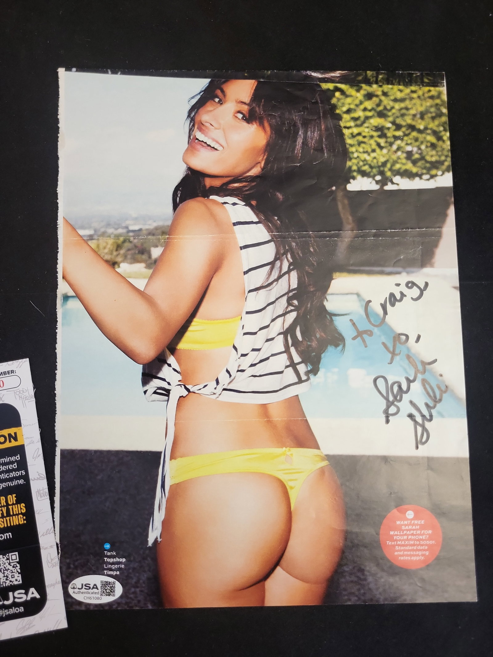 I00921 | Sarah Shahi Personalized Autographed Magazine Tear-Sheet, JSA Authenticated: BID PER WHAT YOU SEE IN THE PHOTO, NOT THE AI GENERATED TITLES AND DESCRIPTIONS! Sarah Shahi Personalized Autographed Magazine Tear-Sheet, JSA Authenticated This lot features a full-color, gloss-finis