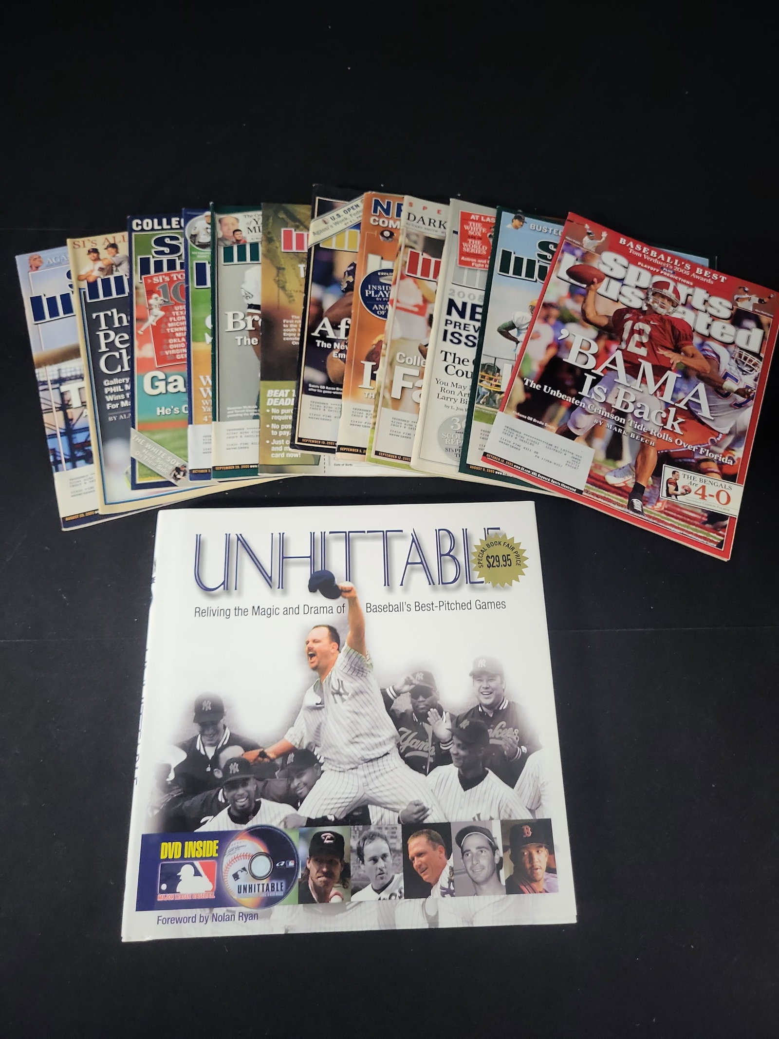 I01327 | A Baseball History Book with DVD and an Assortment of Sports Illustrated Magazines: BID PER WHAT YOU SEE IN THE PHOTO, NOT THE AI GENERATED TITLES AND DESCRIPTIONS! A Baseball History Book with DVD and an Assortment of Sports Illustrated Magazines This lot features a hardcover book t