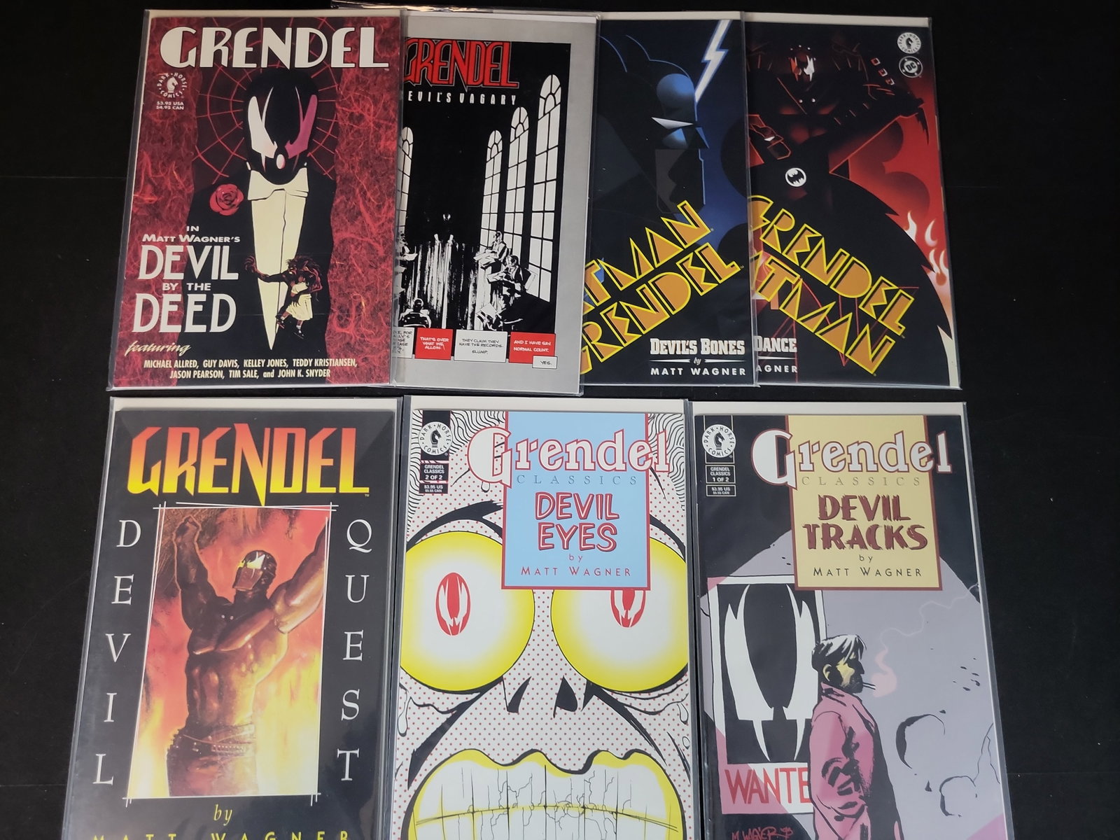 I02375 | A Collection of Seven Grendel Comic Books and Graphic Novels by Matt Wagner: BID PER WHAT YOU SEE IN THE PHOTO, NOT THE AI GENERATED TITLES AND DESCRIPTIONS! A Collection of Seven Grendel Comic Books and Graphic Novels by Matt Wagner This lot consists of seven comic books and 