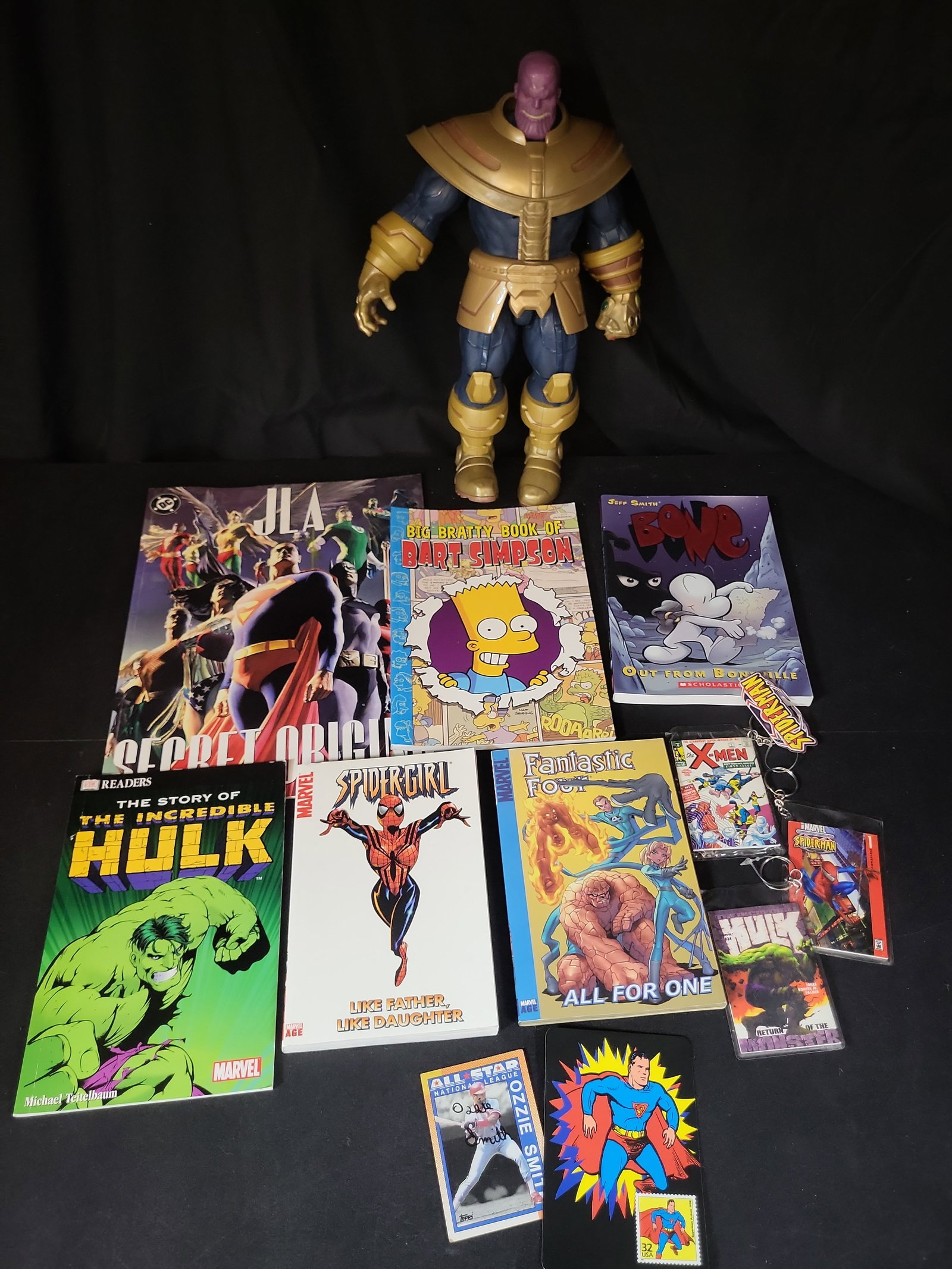 I02929 | An Assortment of Comic Book Memorabilia Including a Thanos Action Figure and Graphic Novels (1 of 7)