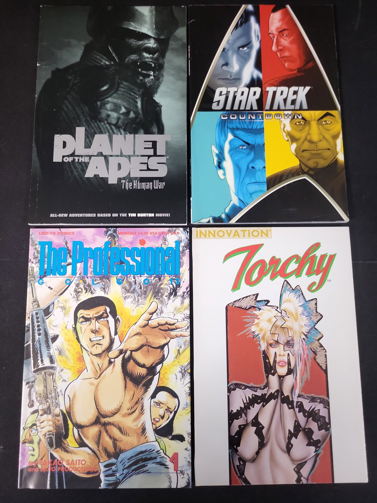 I02351 | A Collection of Four Comic Books and Graphic Novels Including Star Trek, Planet of the: BID PER WHAT YOU SEE IN THE PHOTO, NOT THE AI GENERATED TITLES AND DESCRIPTIONS! A Collection of Four Comic Books and Graphic Novels Including Star Trek, Planet of the Apes, and Golgo 13 A collection 