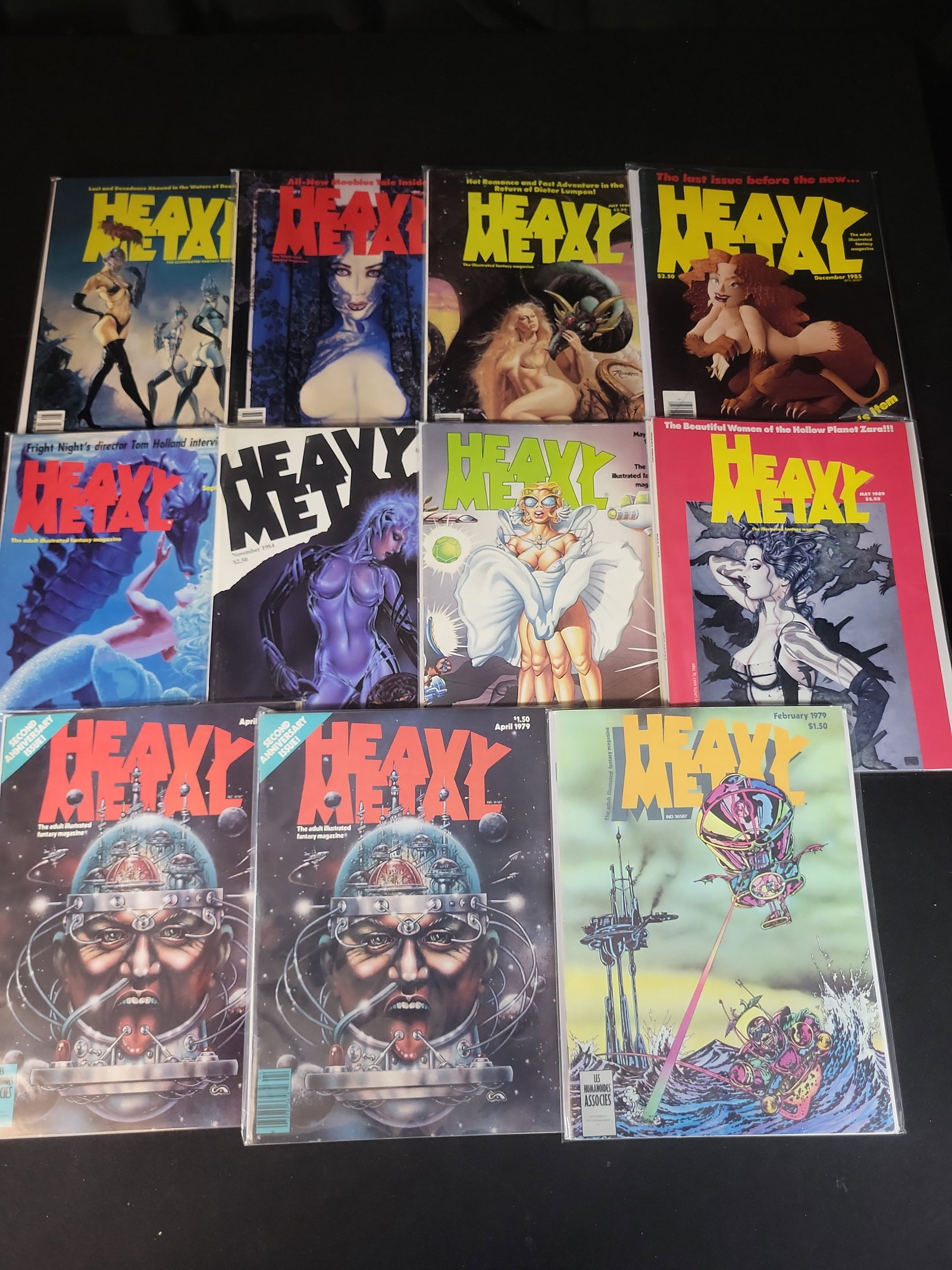 I02590 | A Collection of Eleven Issues of Heavy Metal Magazine. HM Communications, 1979-1989.: BID PER WHAT YOU SEE IN THE PHOTO, NOT THE AI GENERATED TITLES AND DESCRIPTIONS! A Collection of Eleven Issues of Heavy Metal Magazine. HM Communications, 1979-1989. An assortment of eleven issues of 