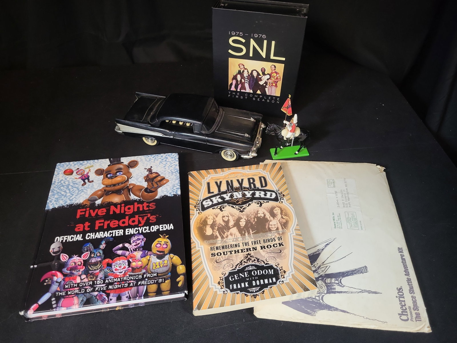 I02938 | An Assortment of Pop Culture Memorabilia Including Books, DVD Box Set, Novelty Telephone, (1 of 11)