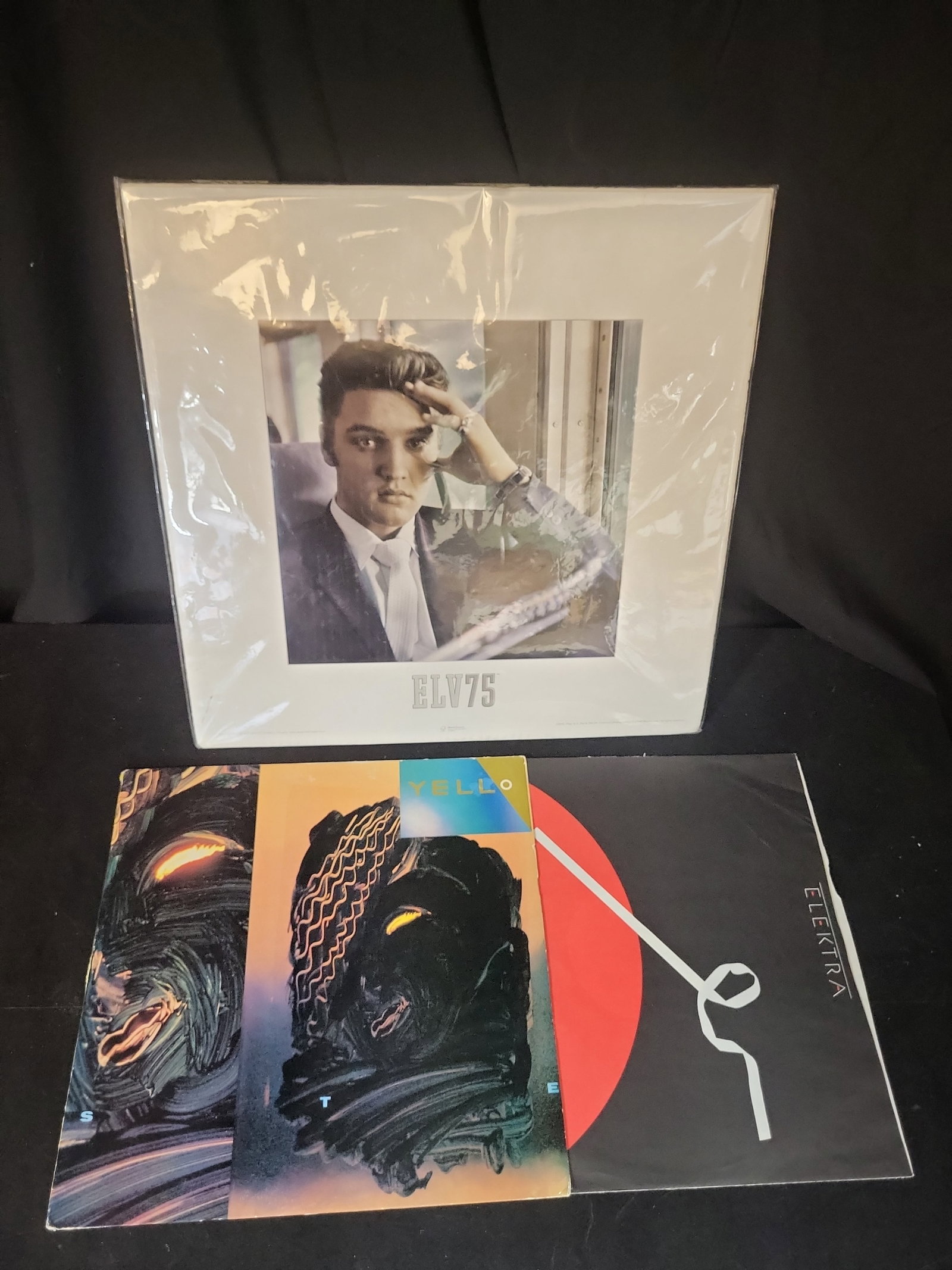 I02946 | A Trio of Music Related Items Including Yello Stella Promotional LP and Elvis Presley ELV75 (1 of 4)
