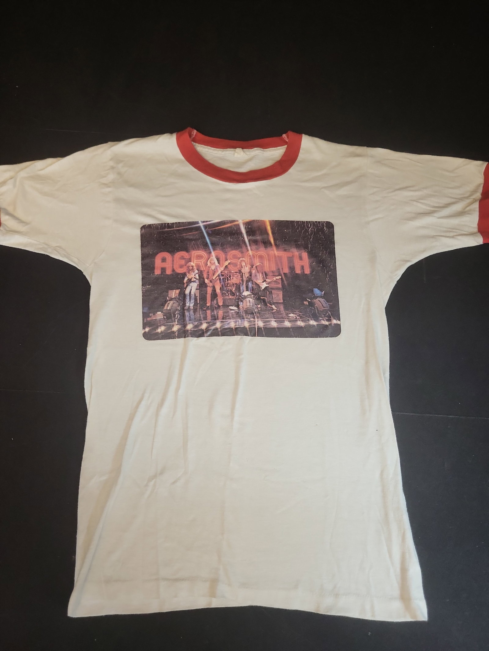 I02754 | Vintage Aerosmith Live Performance Graphic Ringer T-Shirt: BID PER WHAT YOU SEE IN THE PHOTO, NOT THE AI GENERATED TITLES AND DESCRIPTIONS! Vintage Aerosmith Live Performance Graphic Ringer T-Shirt This vintage short-sleeved ringer style t-shirt features the 